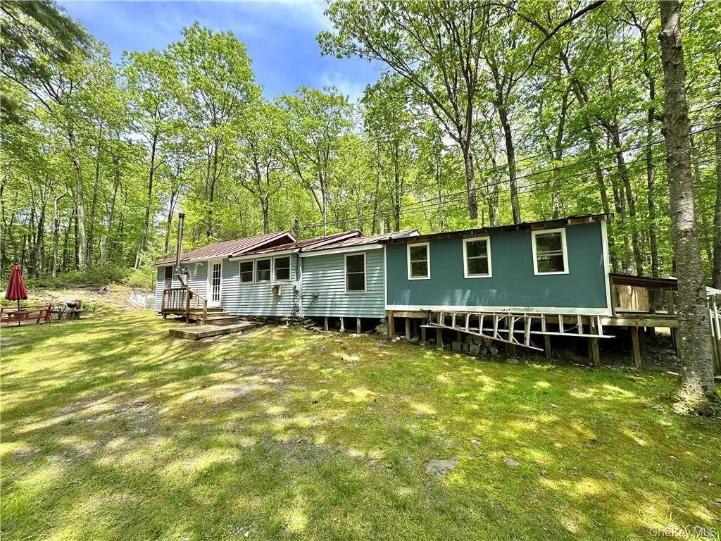 Rear view of property featuring a lawn Rear view of property featuring a lawn