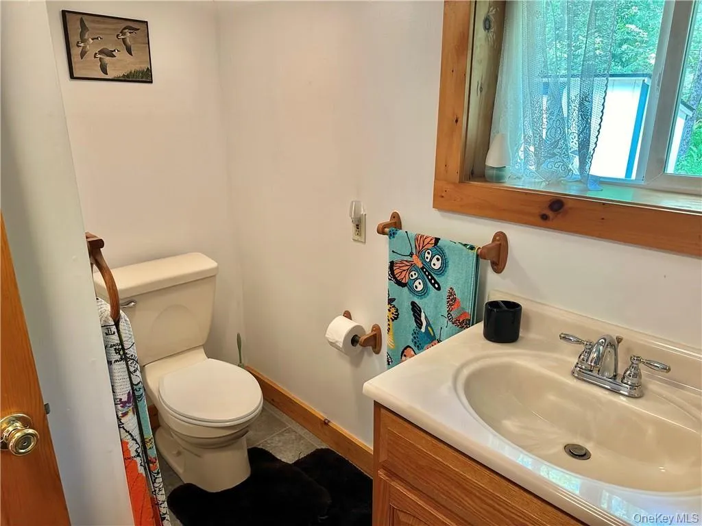 Half bathroom featuring vanity and baseboards Half bathroom featuring vanity and baseboards