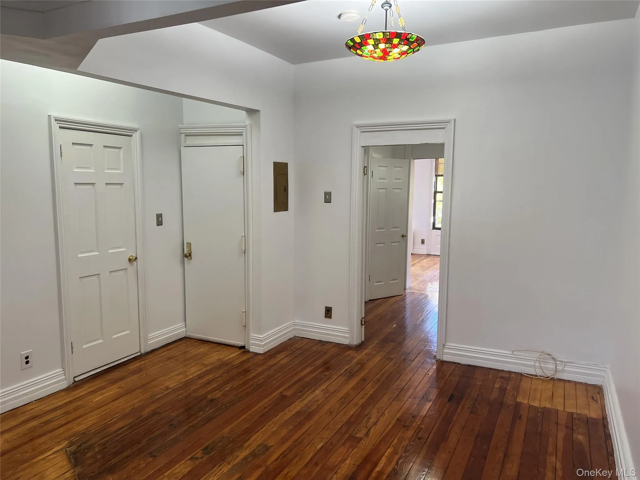 Foyer featuring dark wood-style floors and baseboards Foyer featuring dark wood-style floors and baseboards