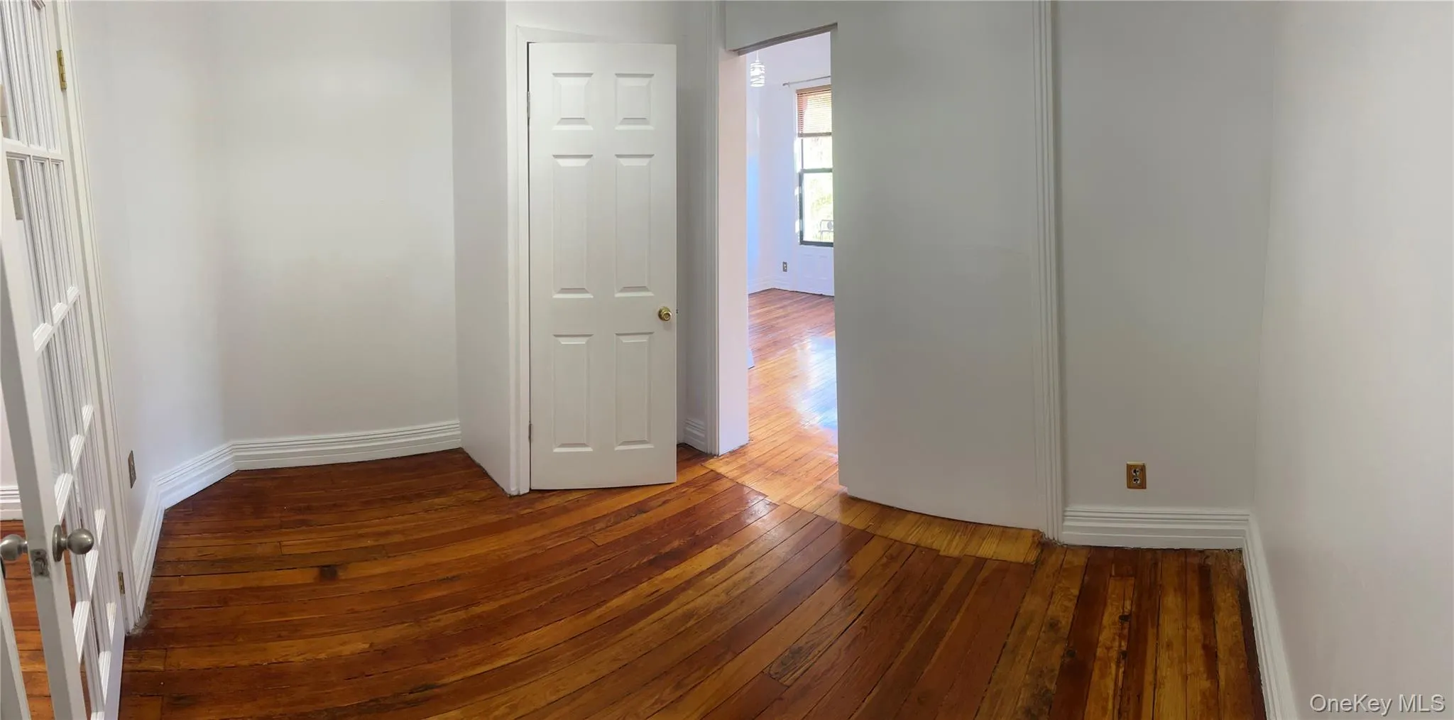 Spare room featuring dark wood-style floors and baseboards Spare room featuring dark wood-style floors and baseboards