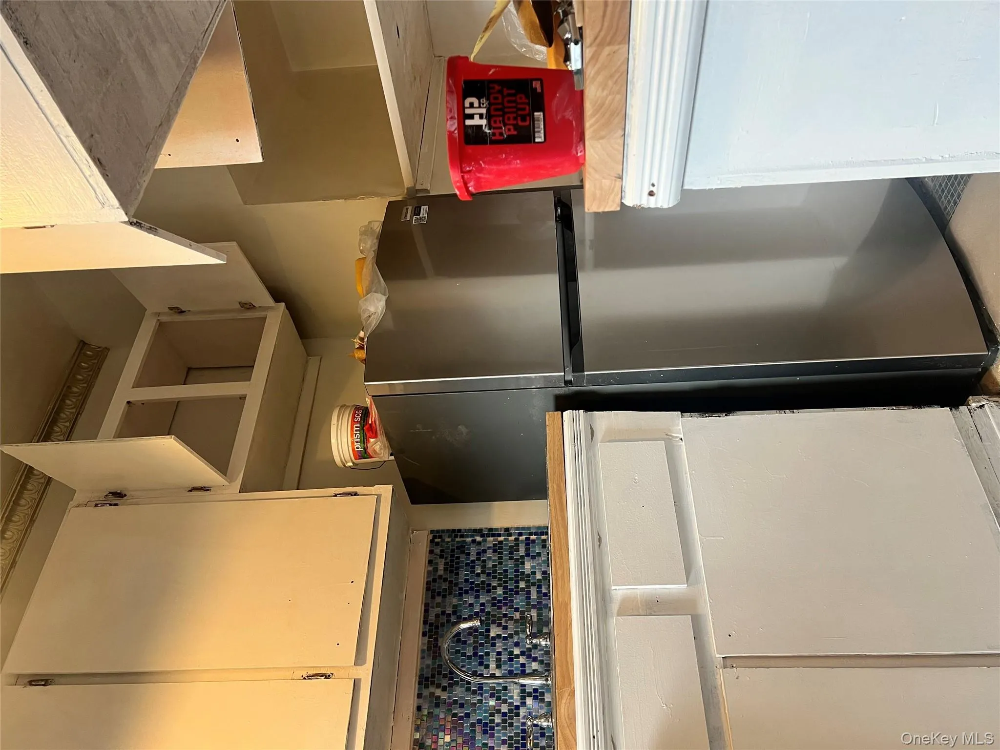 Kitchen featuring freestanding refrigerator and white cabinets Kitchen featuring freestanding refrigerator and white cabinets