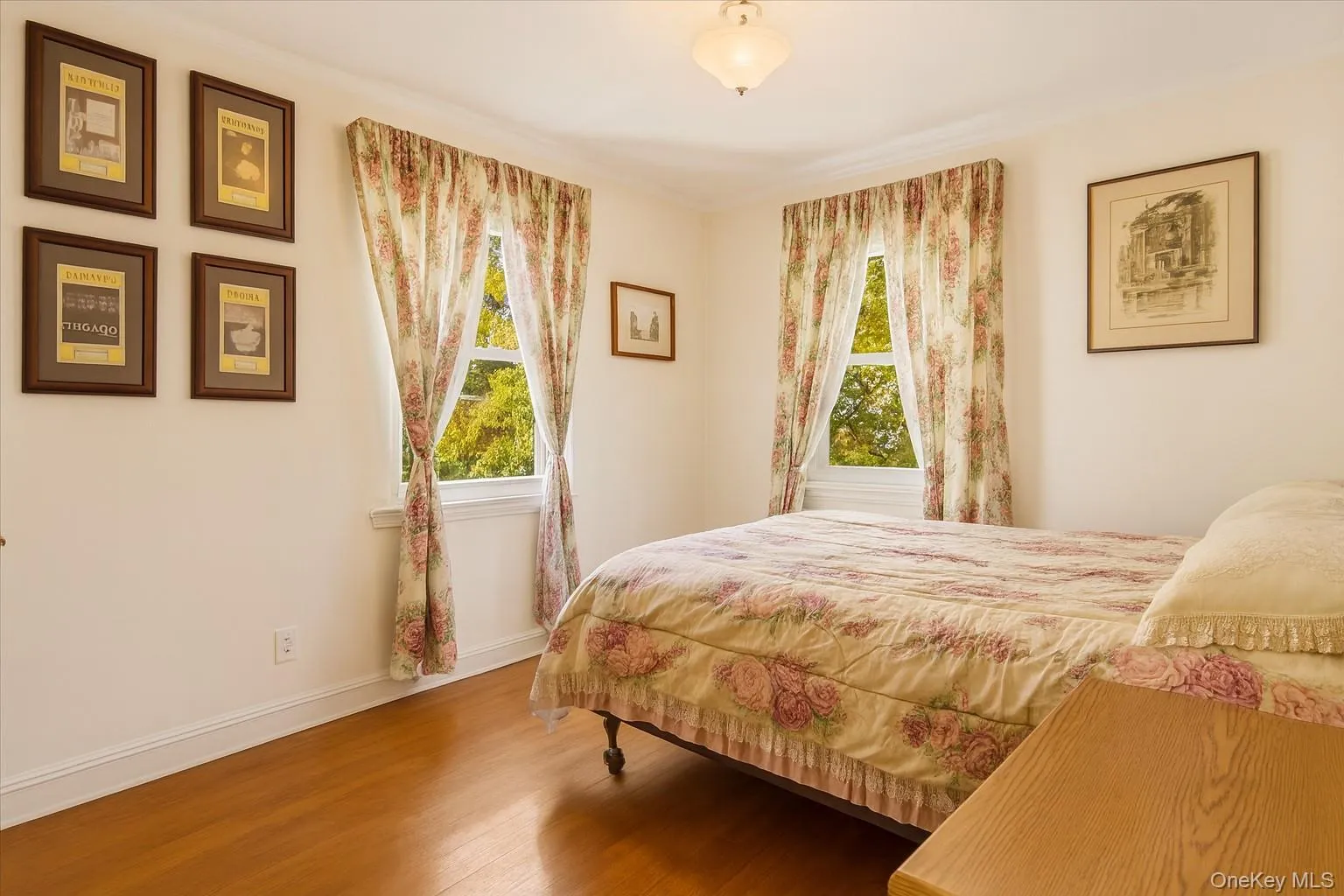 Bedroom with wood finished floors and crown molding Bedroom with wood finished floors and crown molding