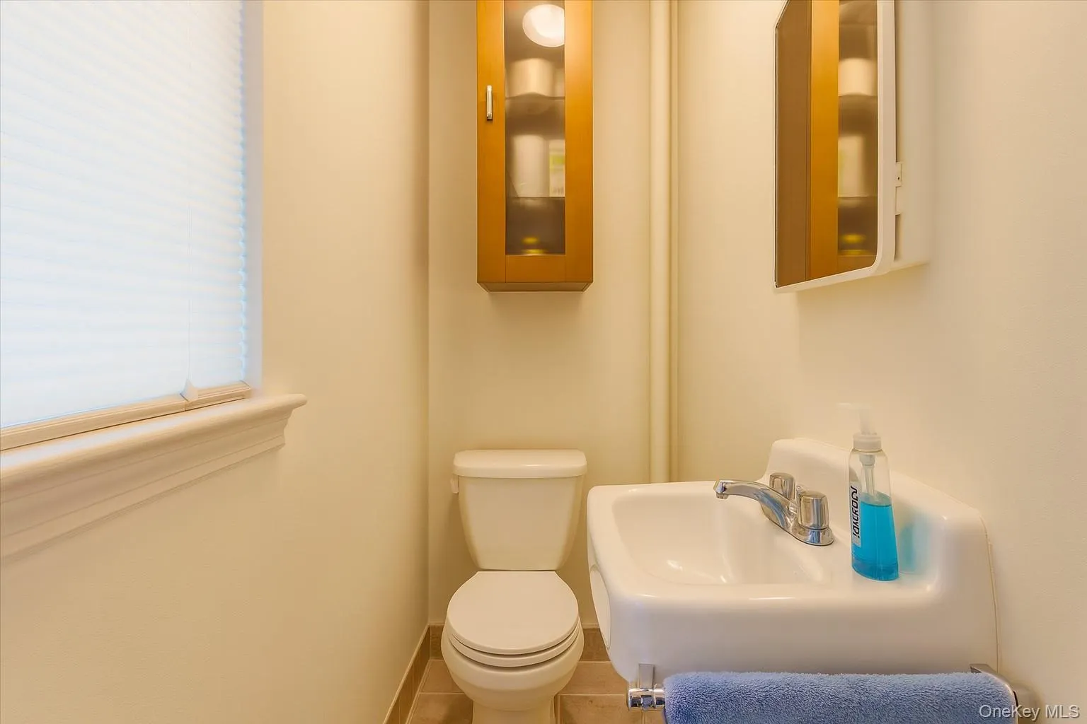 Half bathroom with toilet and tile patterned floors Half bathroom with toilet and tile patterned floors