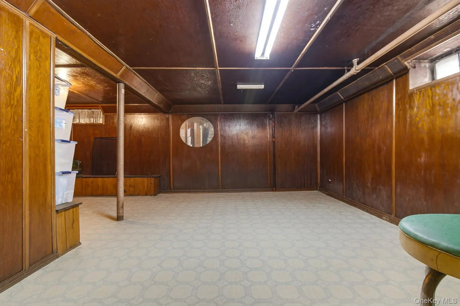 Below grade area featuring wooden walls Below grade area featuring wooden walls