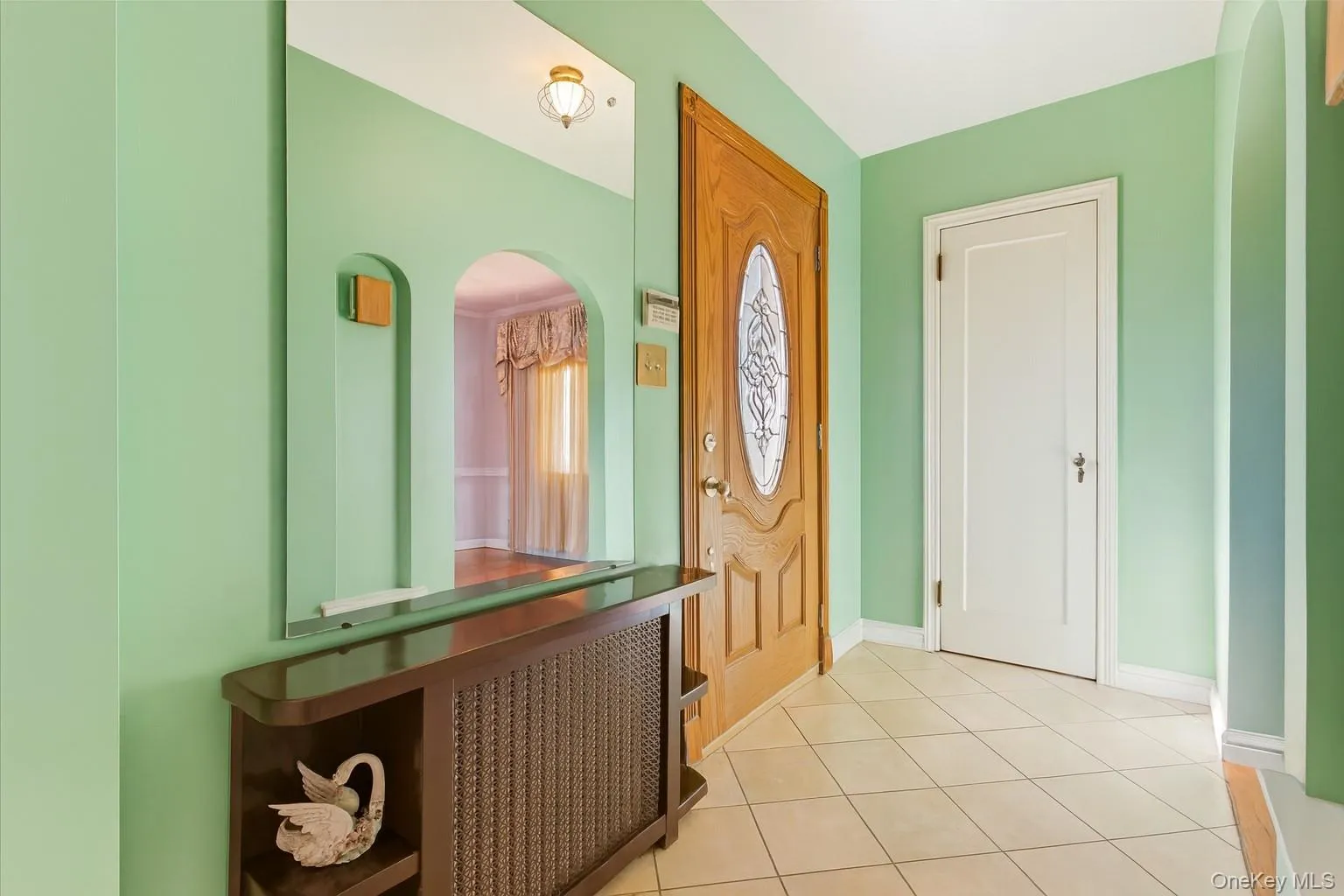 Entryway featuring light tile patterned floors and arched walkways Entryway featuring light tile patterned floors and arched walkways