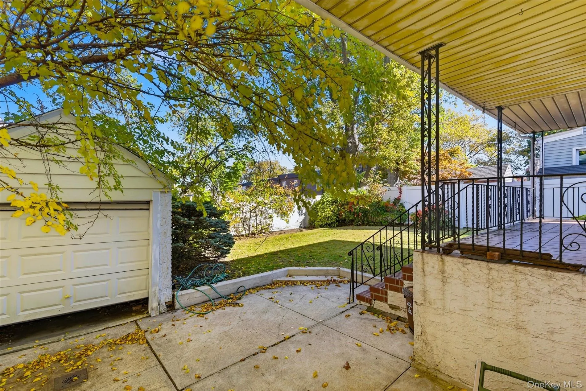 Covered porch with a yard, an outbuilding, and a garage Covered porch with a yard, an outbuilding, and a garage