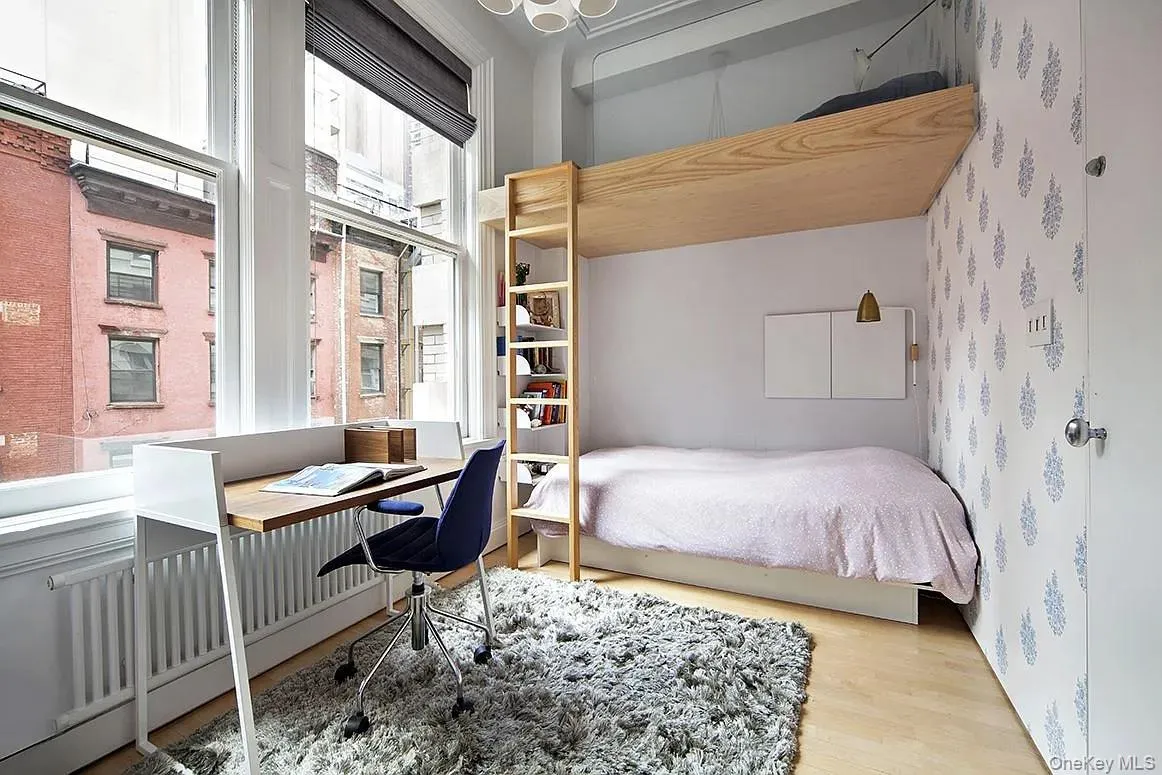 Bedroom featuring a desk and wood finished floors Bedroom featuring a desk and wood finished floors