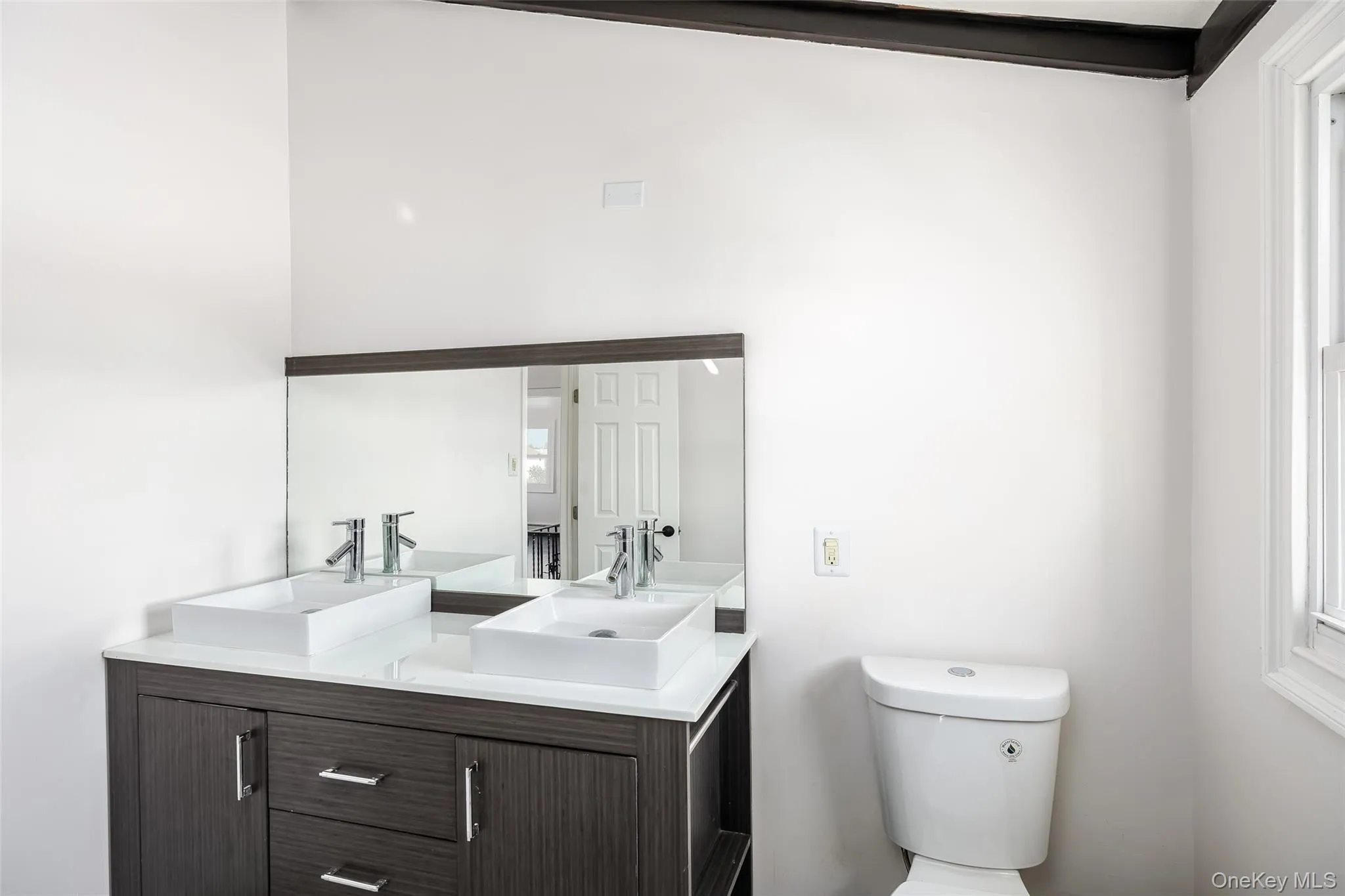 Full bathroom with double vanity and toilet Full bathroom with double vanity and toilet