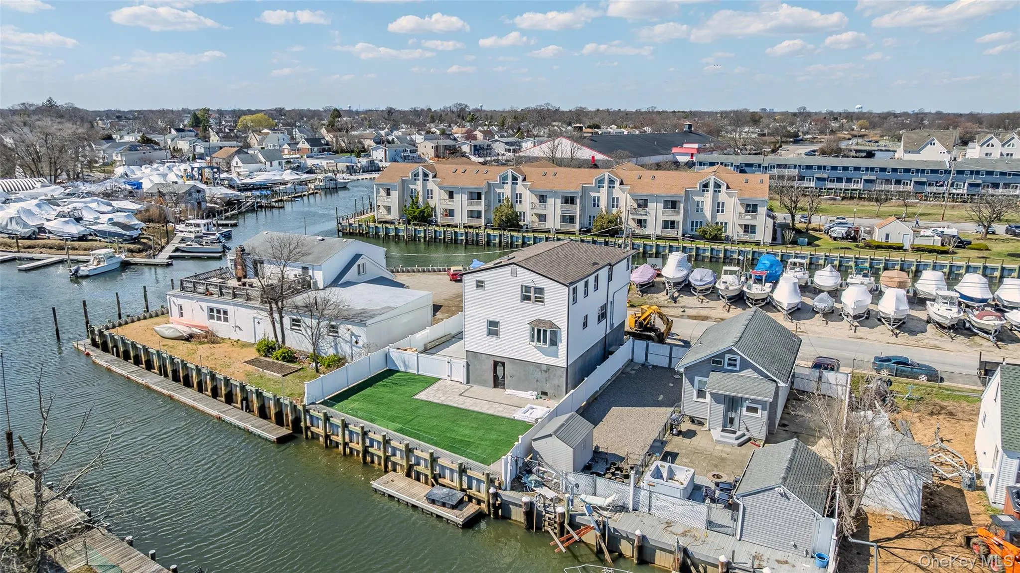 Aerial perspective of suburban area featuring a nearby body of water Aerial perspective of suburban area featuring a nearby body of water