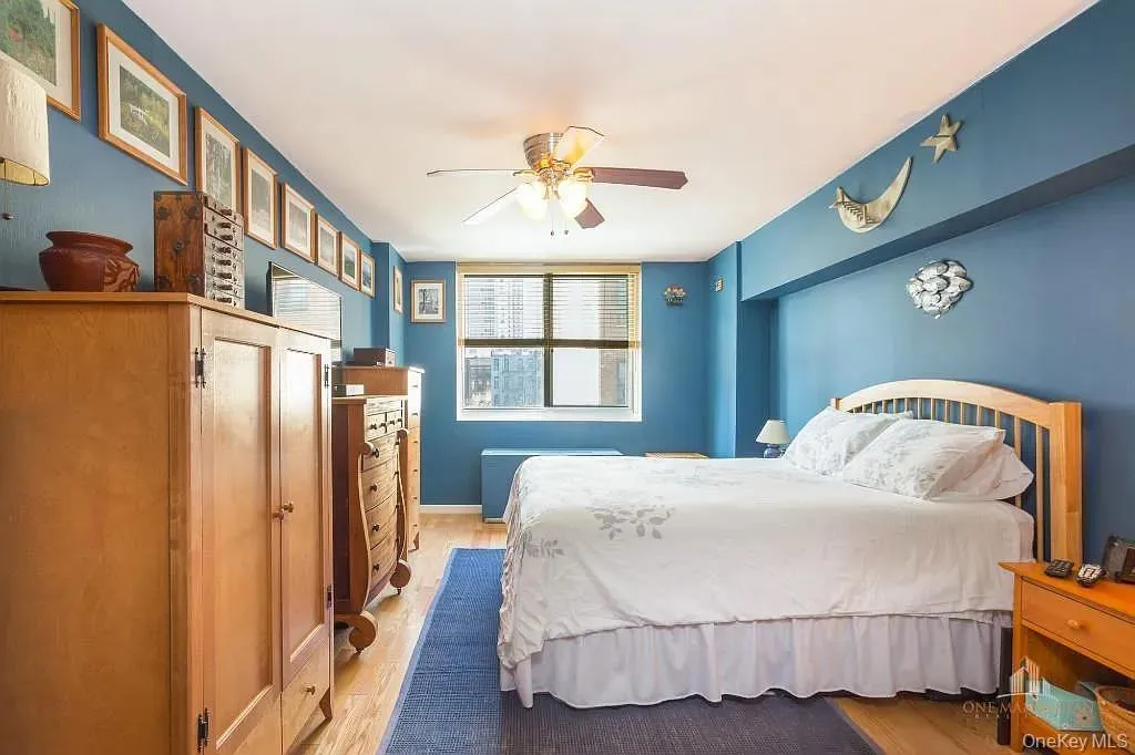 Bedroom with light wood-style flooring and ceiling fan Bedroom with light wood-style flooring and ceiling fan