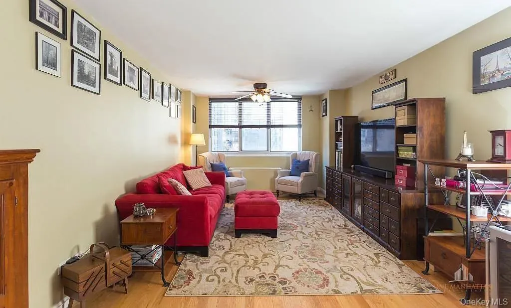 Living room featuring light wood finished floors and ceiling fan Living room featuring light wood finished floors and ceiling fan