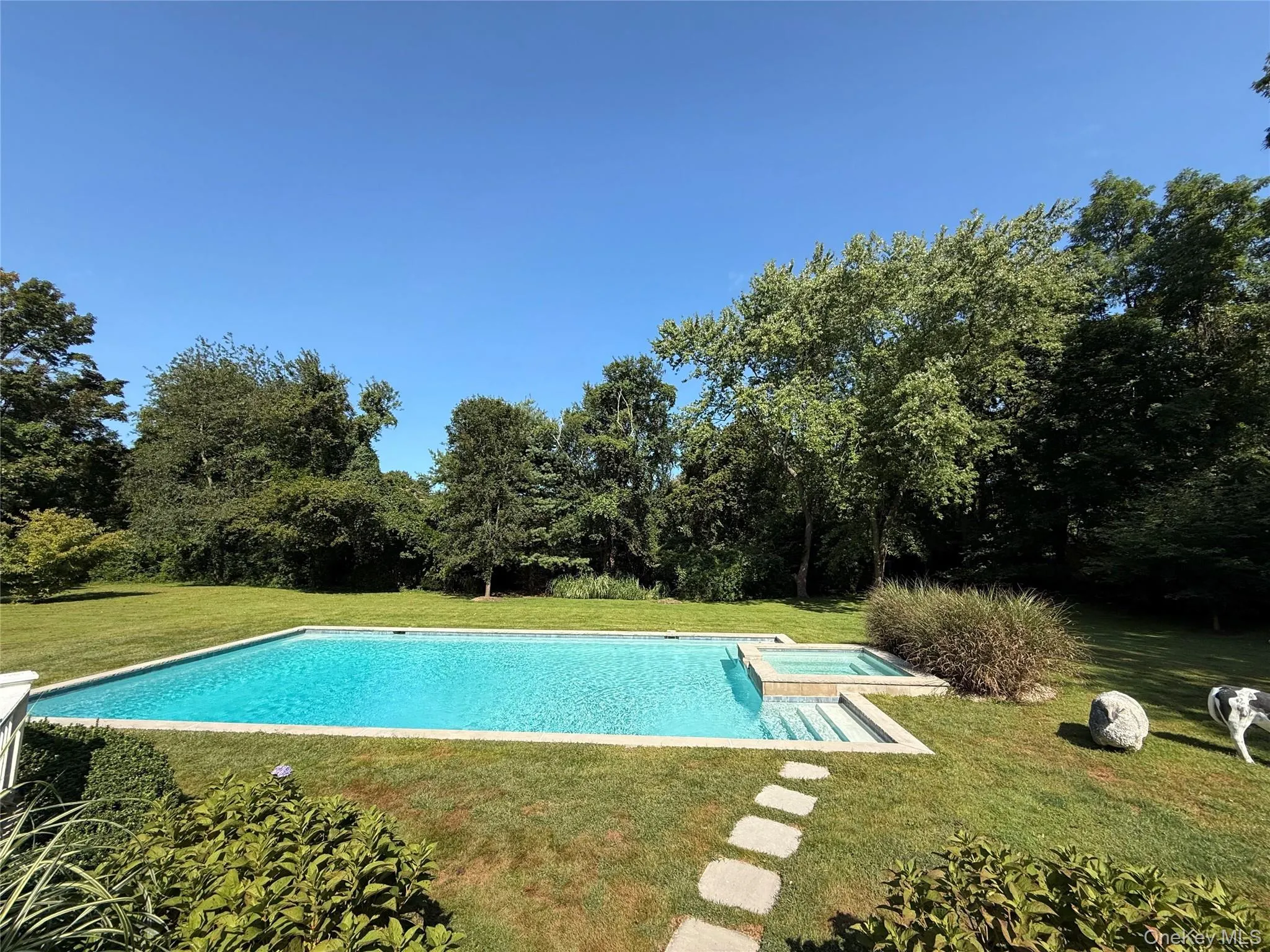 View of swimming pool with a lawn, a patio area, and a pool with connected hot tub View of swimming pool with a lawn, a patio area, and a pool with connected hot tub