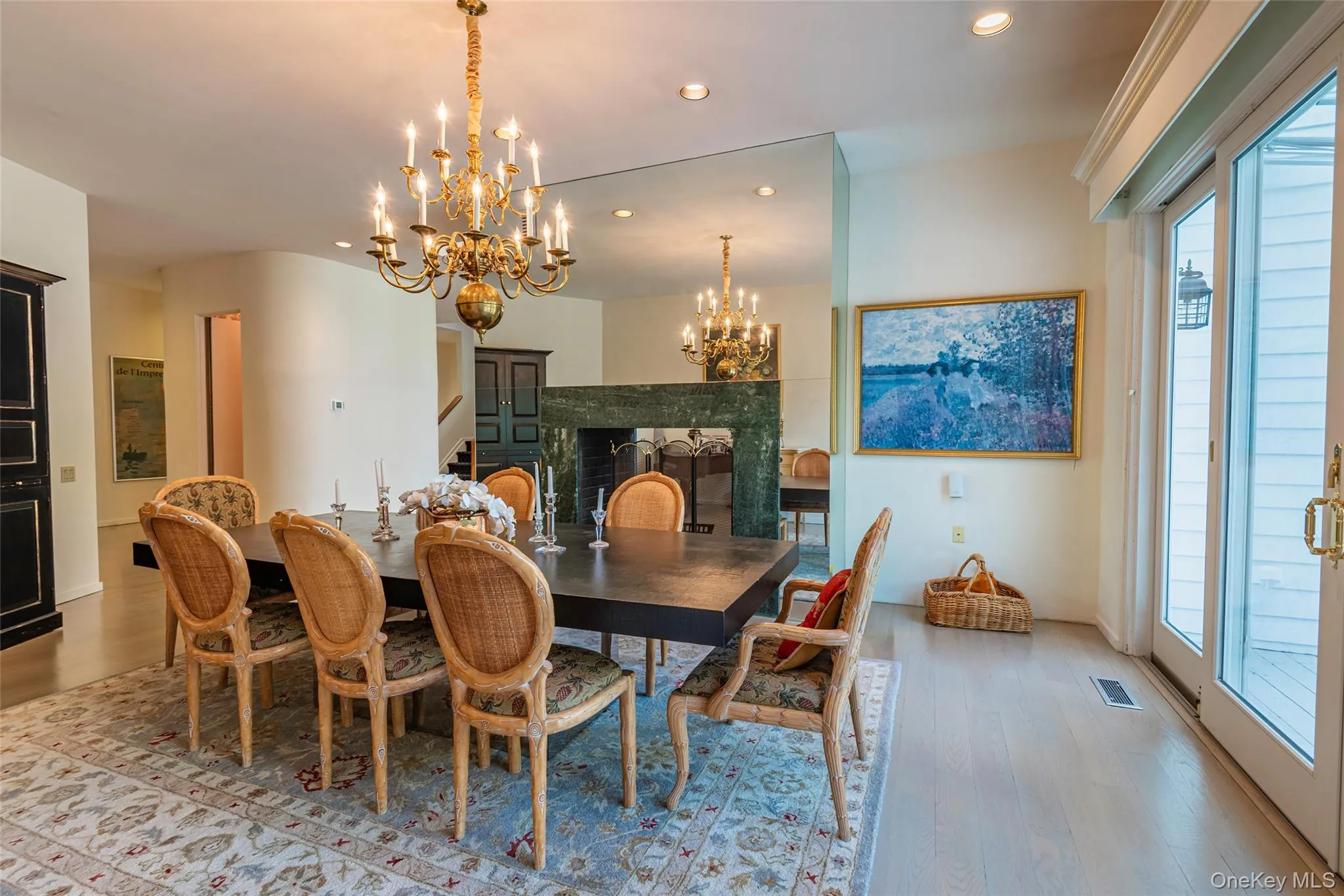 Dining space with recessed lighting, wood finished floors, and a chandelier Dining space with recessed lighting, wood finished floors, and a chandelier