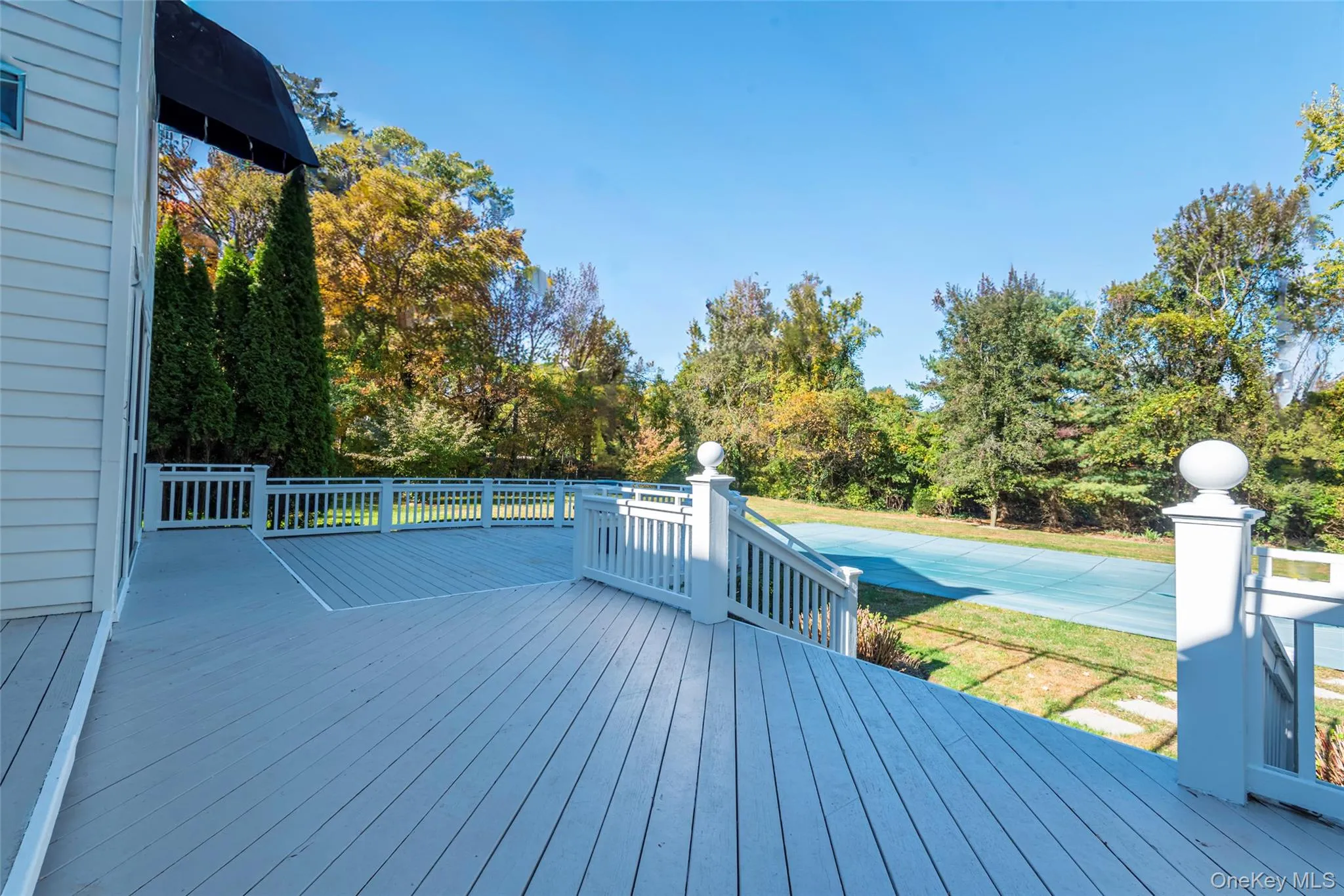 Deck featuring a lawn and a swimming pool Deck featuring a lawn and a swimming pool