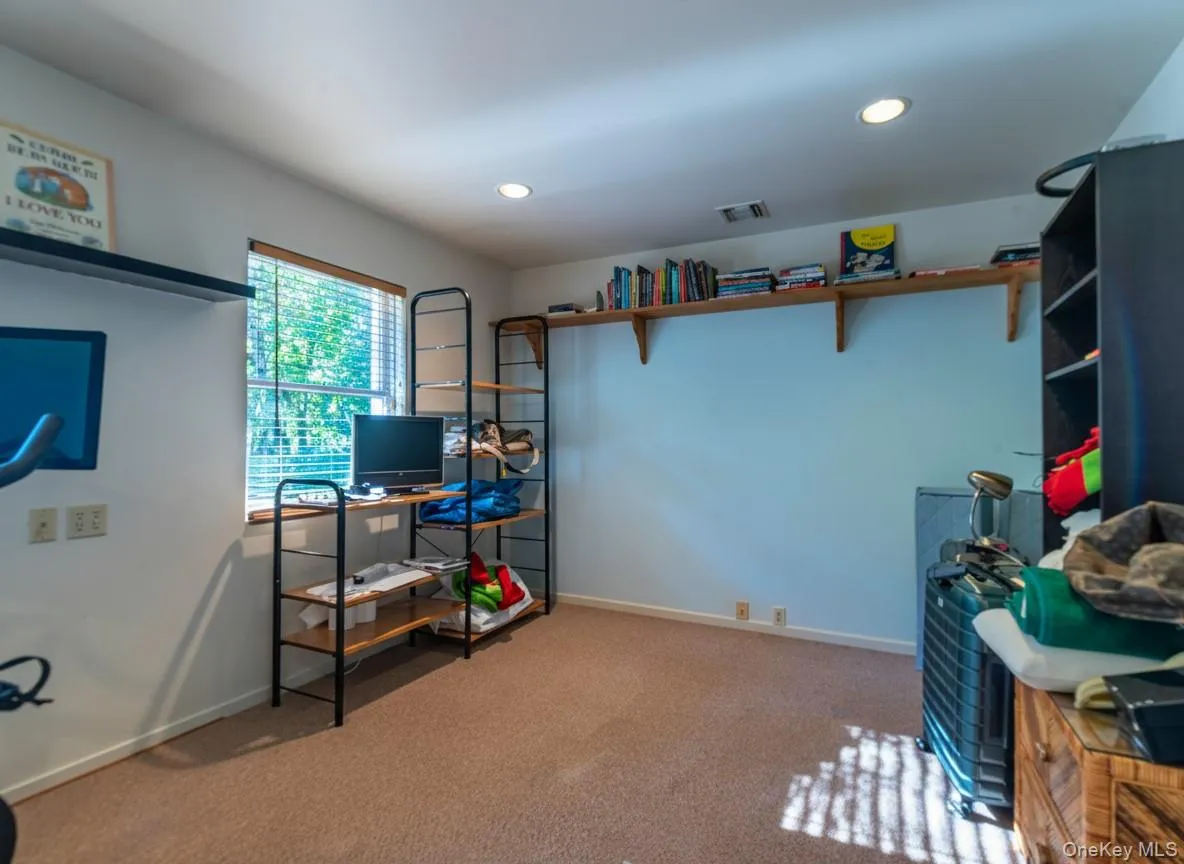 Office space with light colored carpet and recessed lighting Office space with light colored carpet and recessed lighting