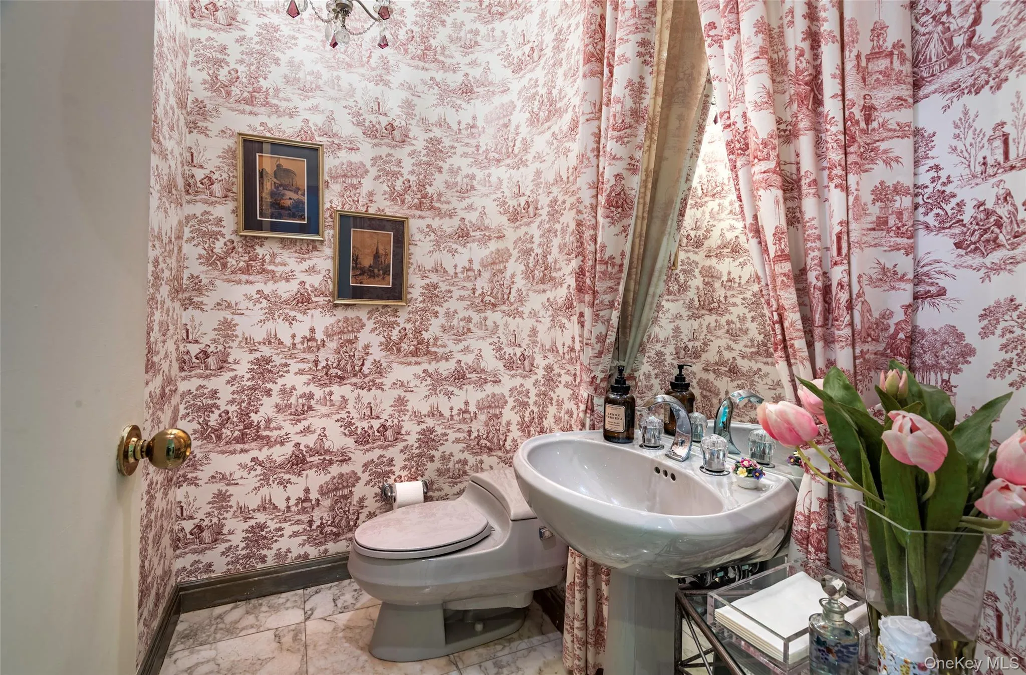 Half bathroom with wallpapered walls Half bathroom with wallpapered walls
