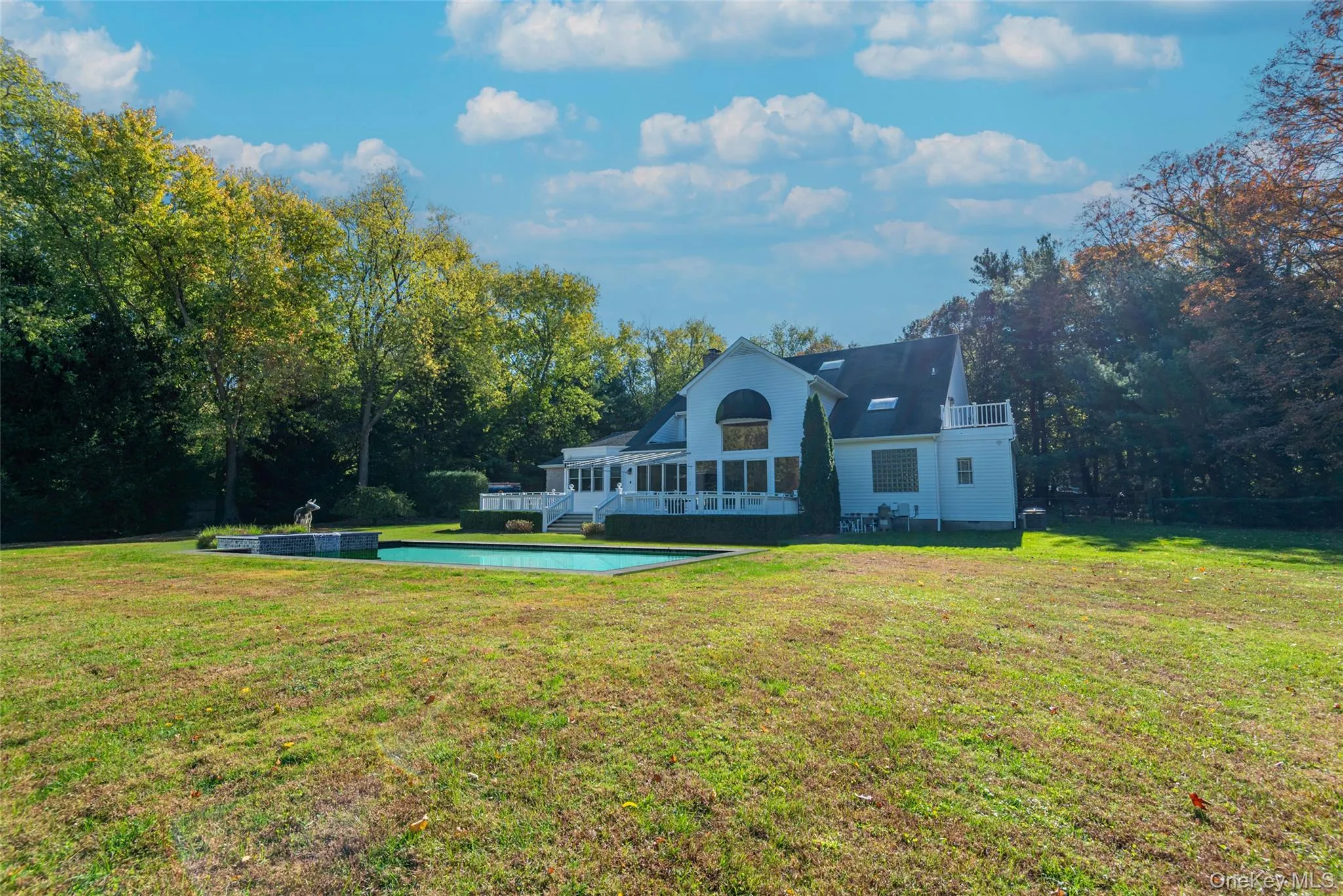 Rear view of house with a yard, a patio, and an outdoor pool Rear view of house with a yard, a patio, and an outdoor pool