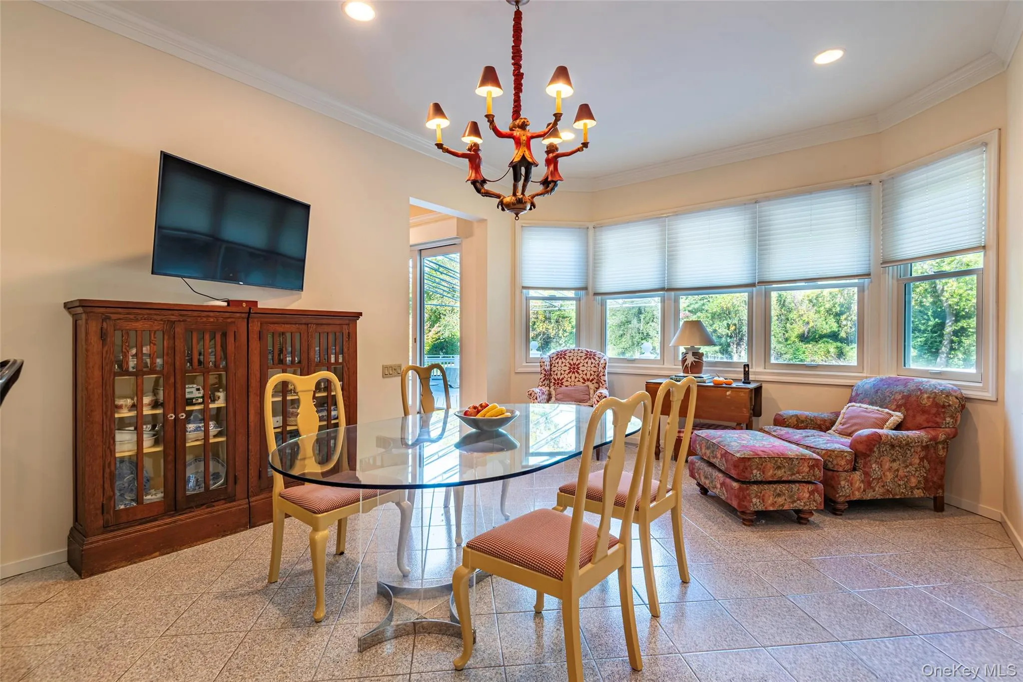 Dining room with ornamental molding, granite floors, recessed lighting, and a chandelier Dining room with ornamental molding, granite floors, recessed lighting, and a chandelier