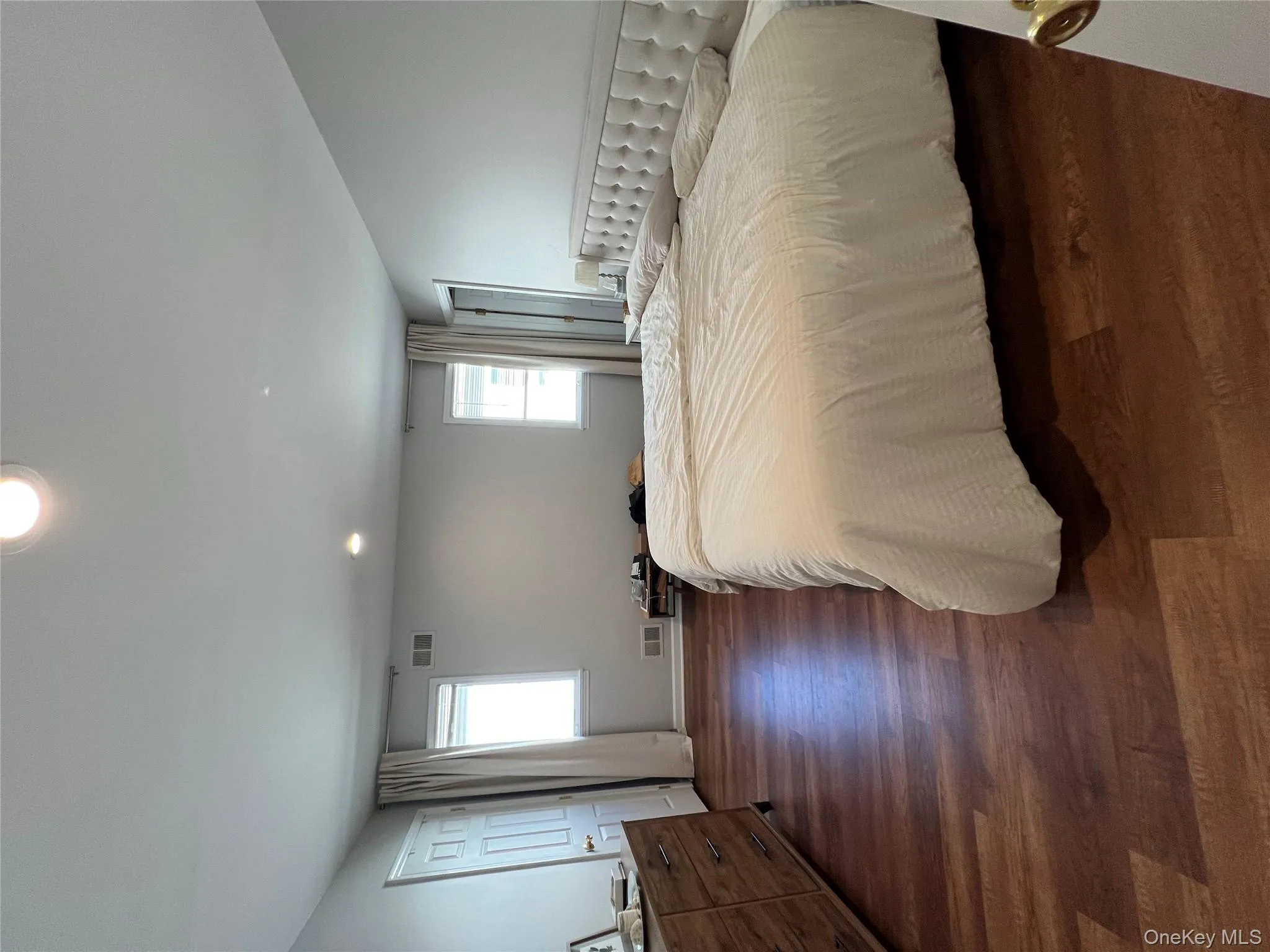 Bedroom with multiple windows, recessed lighting, and dark wood-style floors Bedroom with multiple windows, recessed lighting, and dark wood-style floors