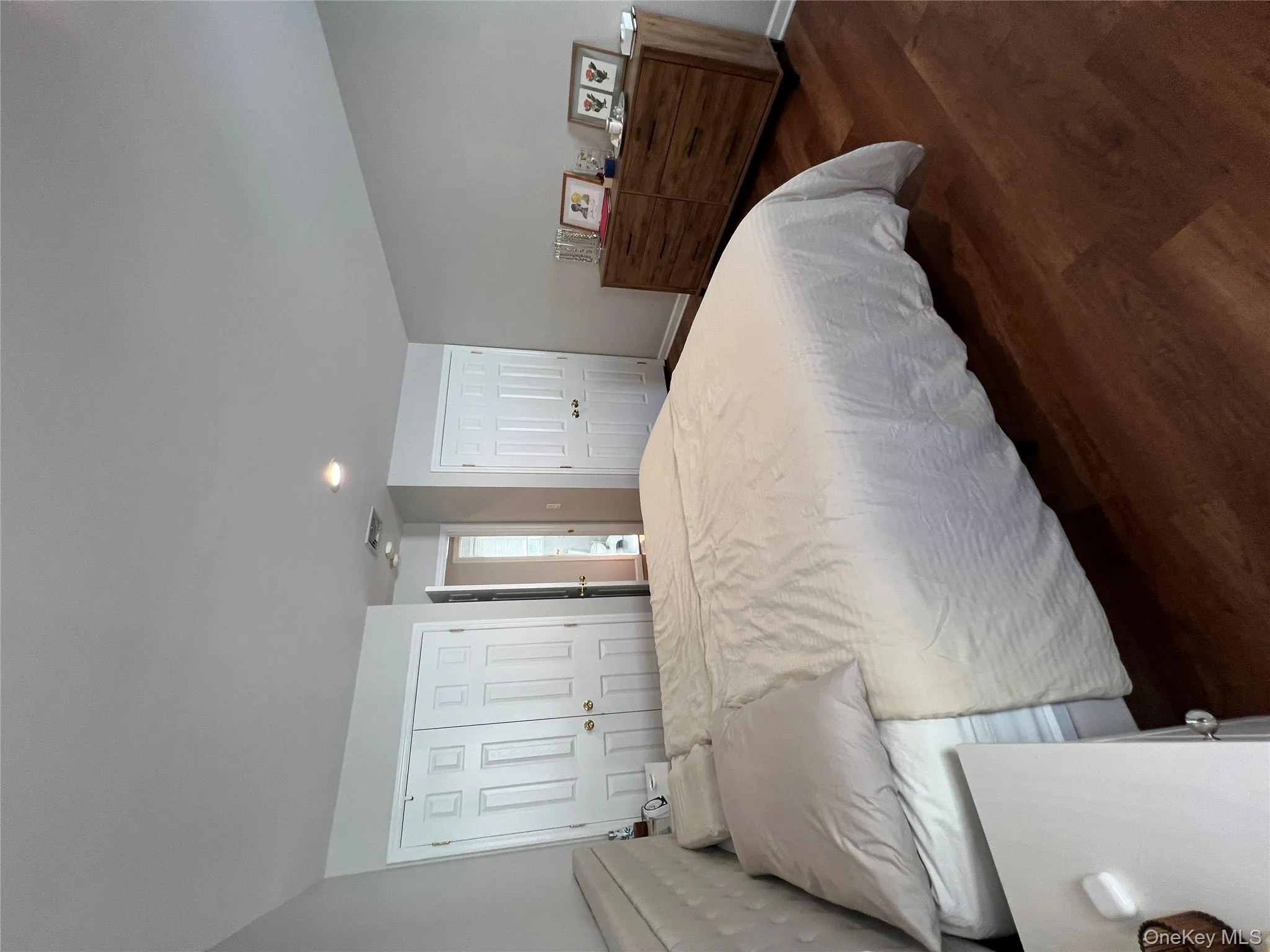 Bedroom with multiple closets, dark wood-style floors, and recessed lighting Bedroom with multiple closets, dark wood-style floors, and recessed lighting
