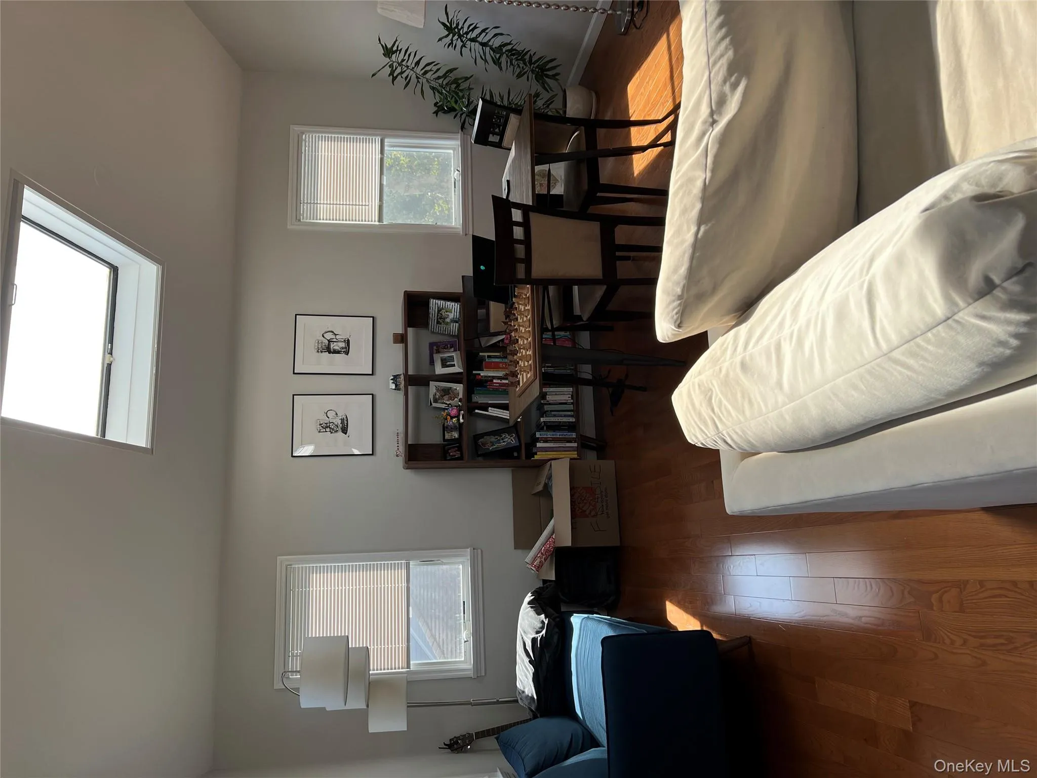Living room with wood finished floors and a skylight Living room with wood finished floors and a skylight