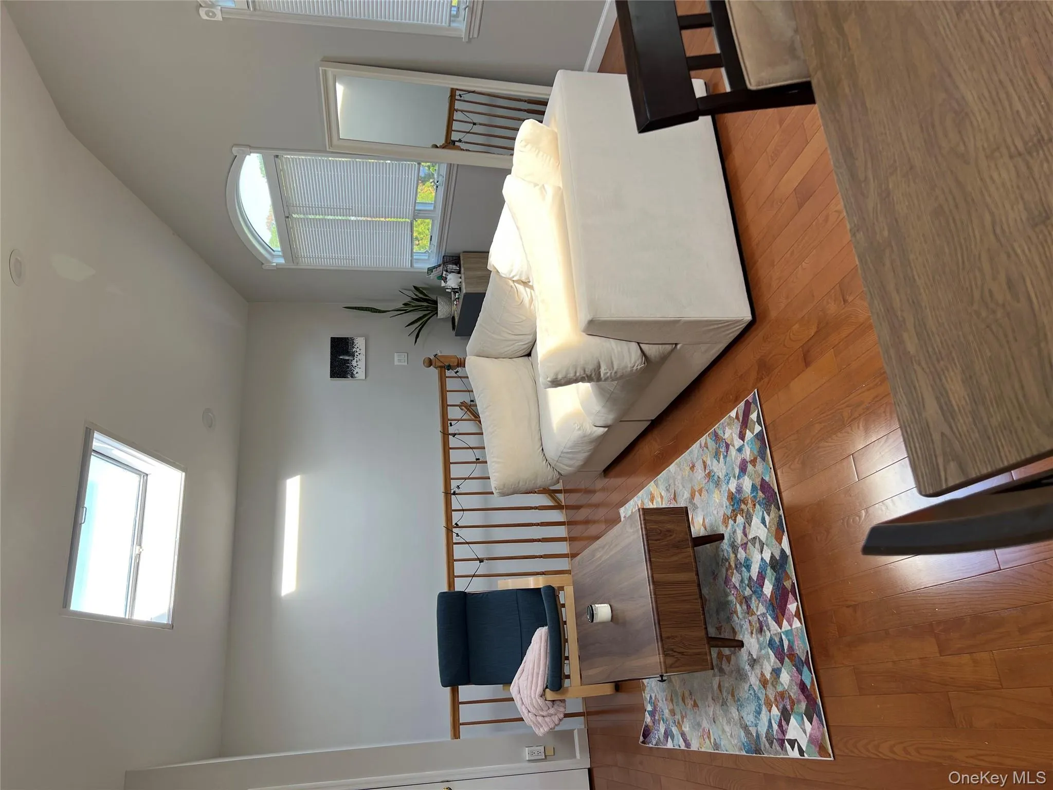 Living area featuring a skylight, vaulted ceiling, and wood-type flooring Living area featuring a skylight, vaulted ceiling, and wood-type flooring