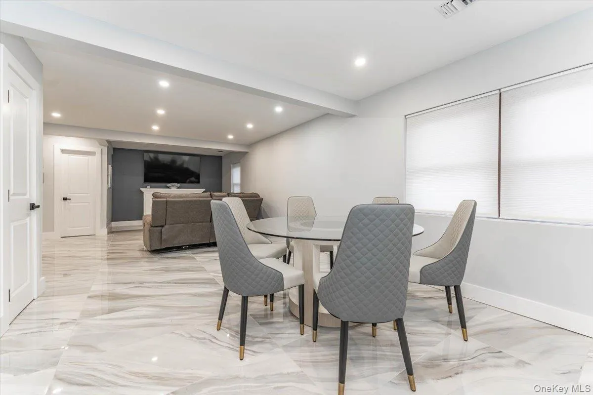 Dining room with light marble finish flooring and recessed lighting Dining room with light marble finish flooring and recessed lighting