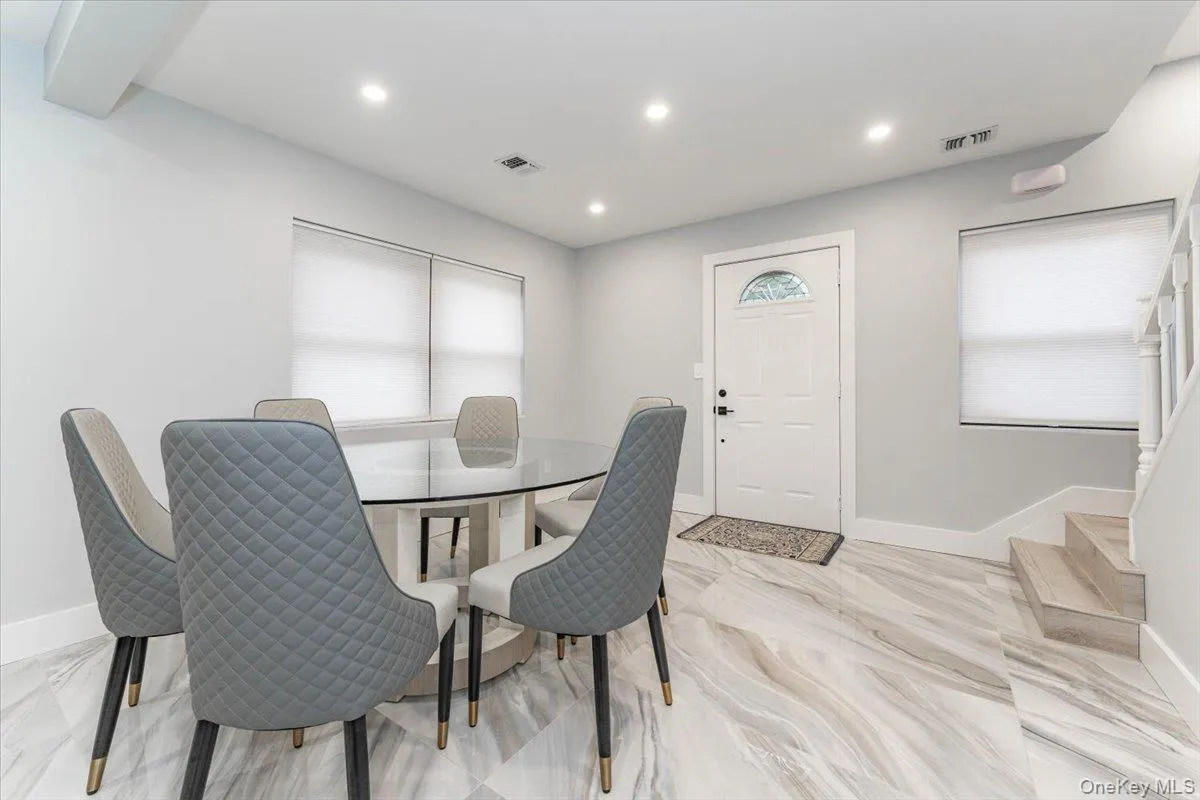 Dining room featuring healthy amount of natural light, recessed lighting, and light marble finish floors Dining room featuring healthy amount of natural light, recessed lighting, and light marble finish floors