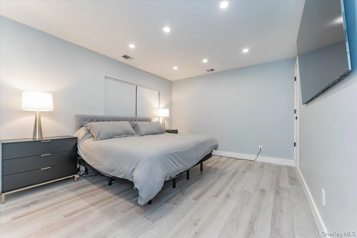 Bedroom with recessed lighting and light wood-type flooring Bedroom with recessed lighting and light wood-type flooring