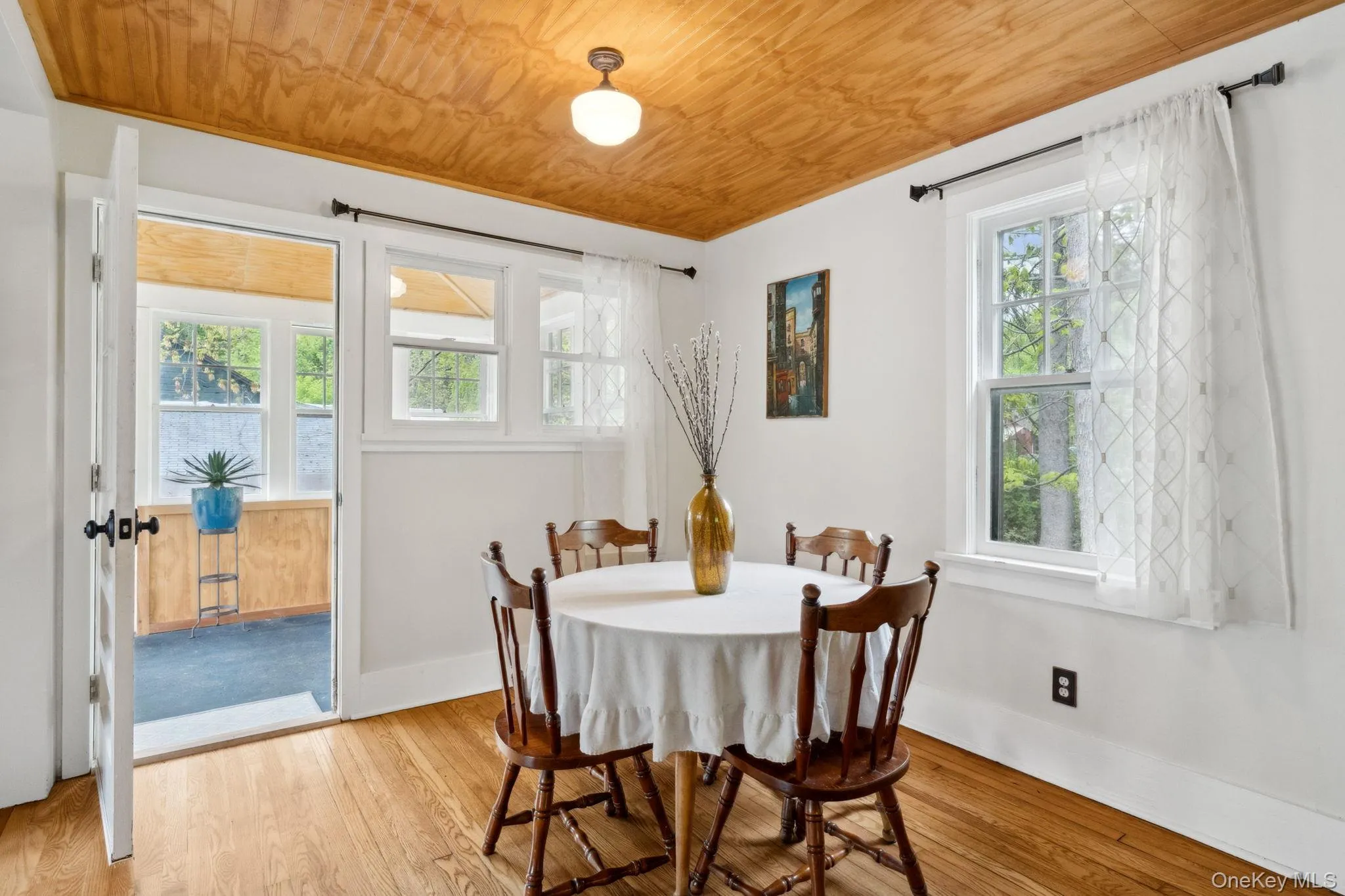 Dining space with light wood-type flooring, healthy amount of natural light, and wooden ceiling Dining space with light wood-type flooring, healthy amount of natural light, and wooden ceiling