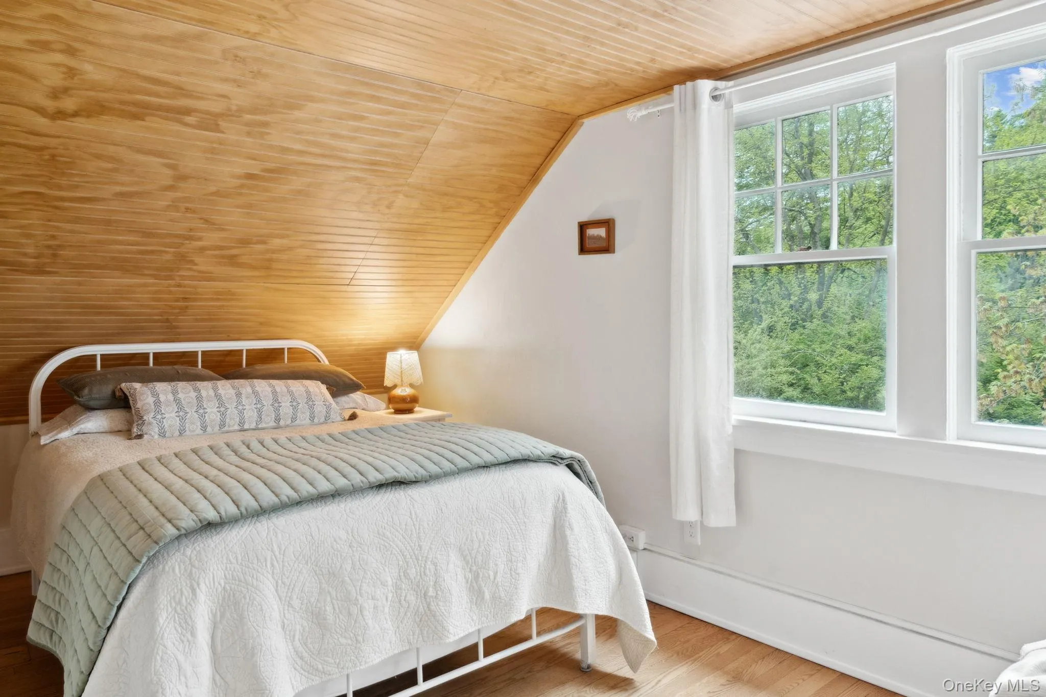 Bedroom featuring wooden ceiling, wood finished floors, and lofted ceiling Bedroom featuring wooden ceiling, wood finished floors, and lofted ceiling