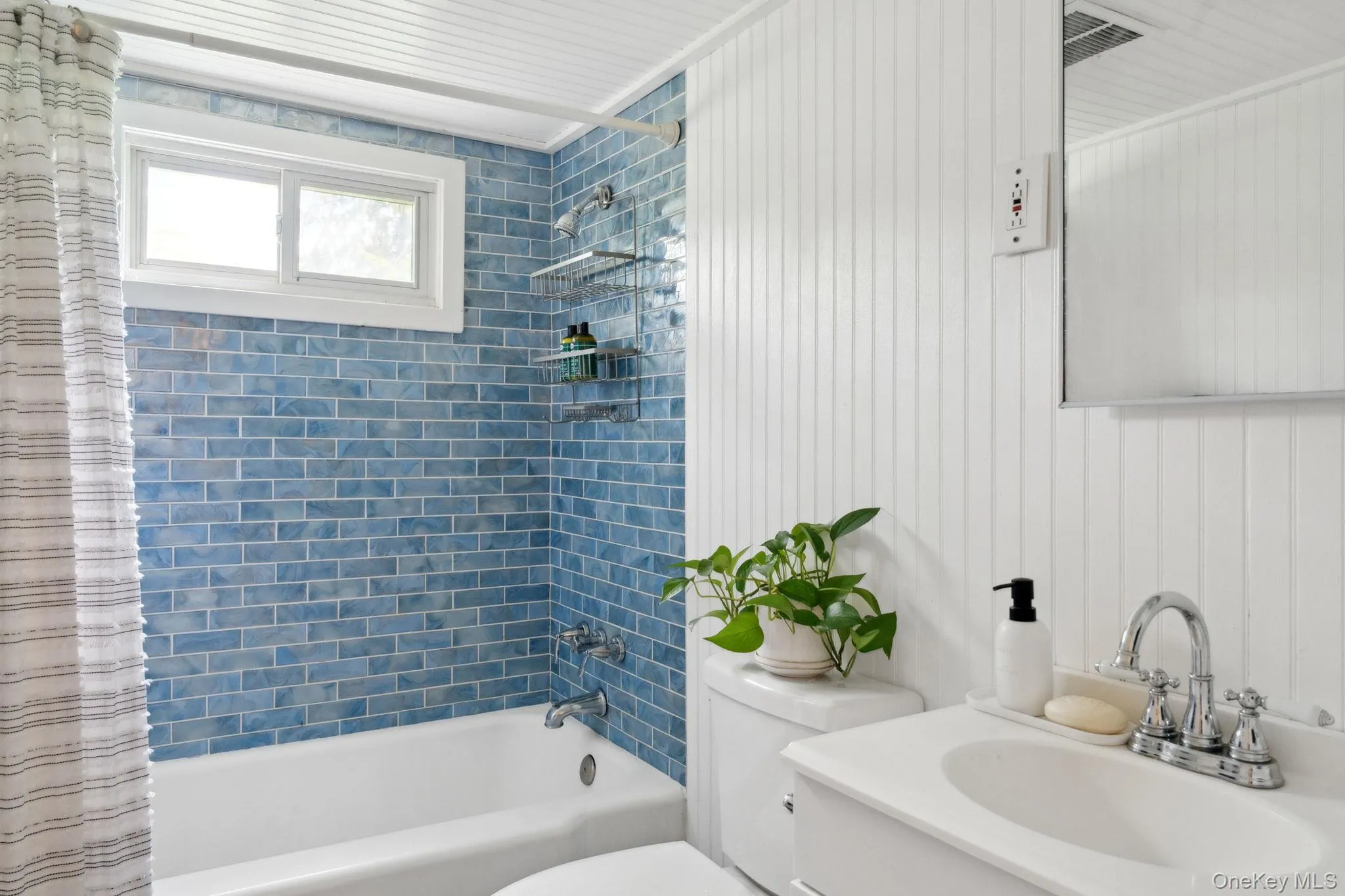 Bathroom with shower / bath combo with shower curtain and vanity Bathroom with shower / bath combo with shower curtain and vanity