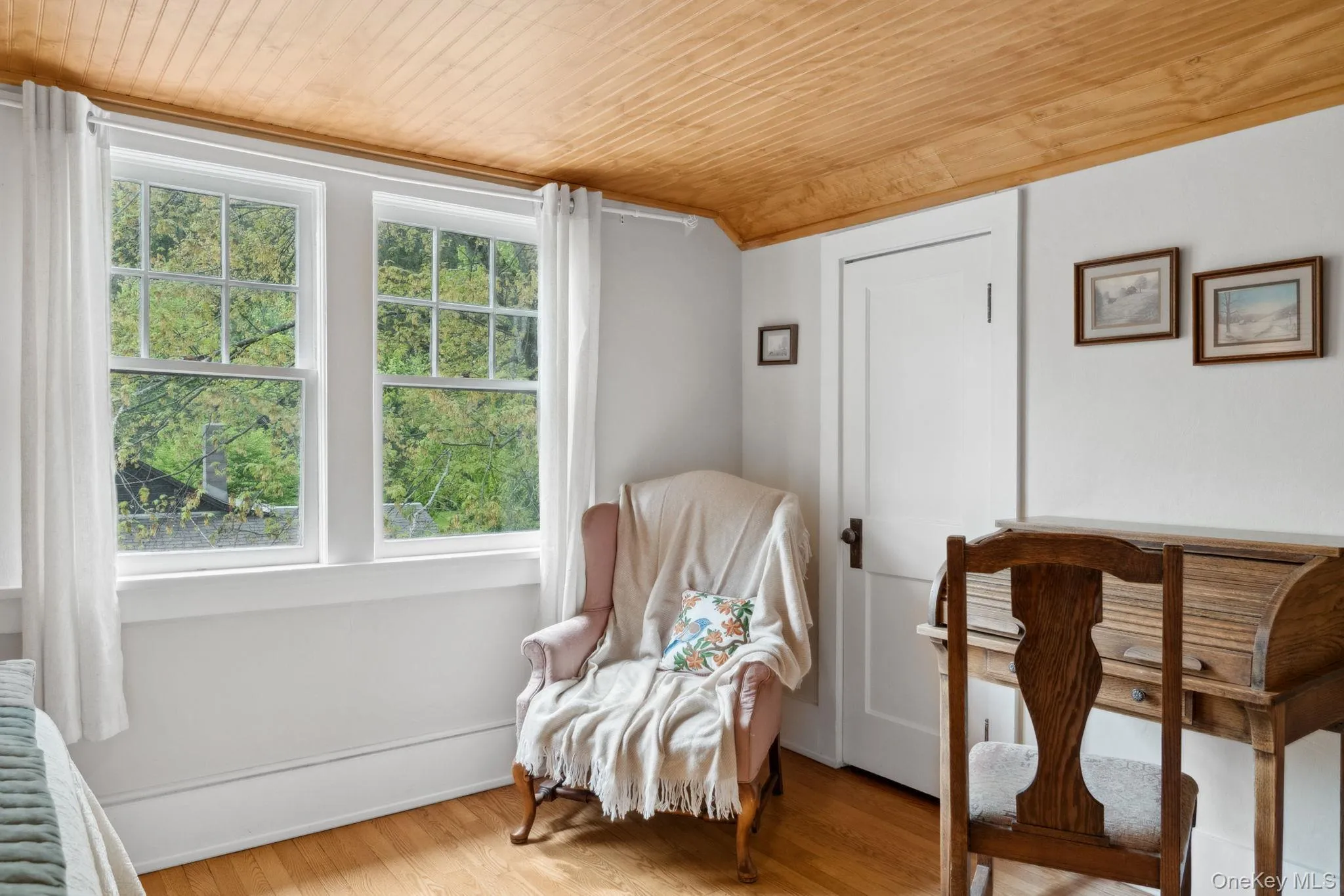 Living area featuring wood ceiling, wood finished floors, and radiator heating unit Living area featuring wood ceiling, wood finished floors, and radiator heating unit