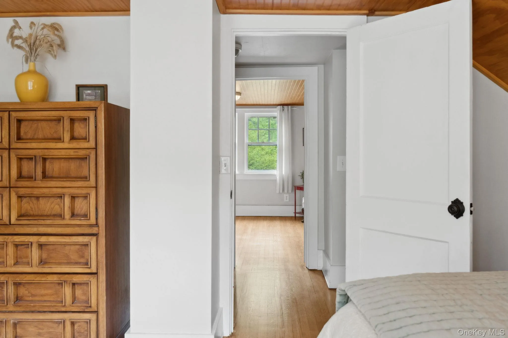 Bedroom with light wood-style flooring and wooden ceiling Bedroom with light wood-style flooring and wooden ceiling