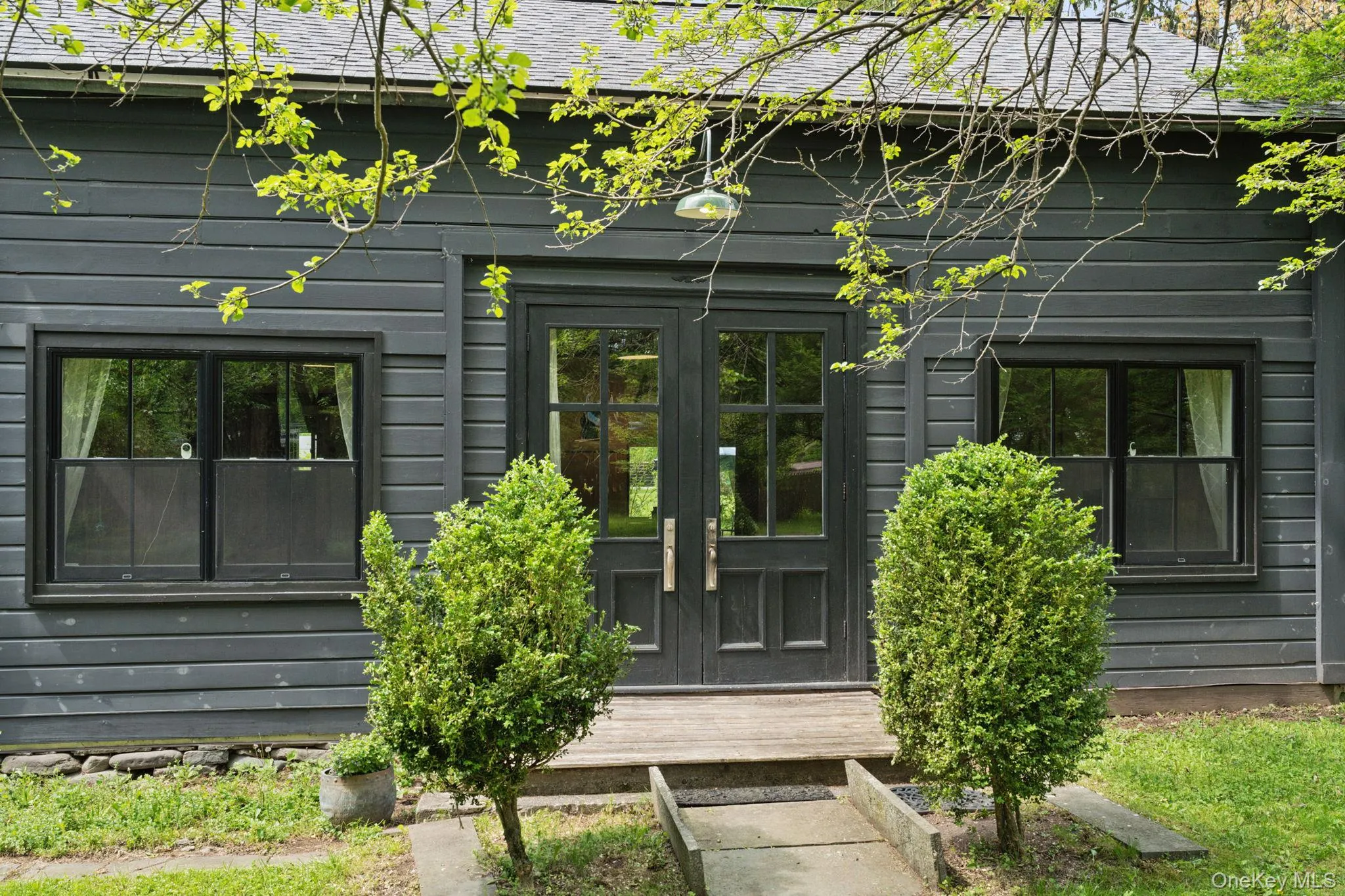 View of exterior entry featuring roof with shingles View of exterior entry featuring roof with shingles