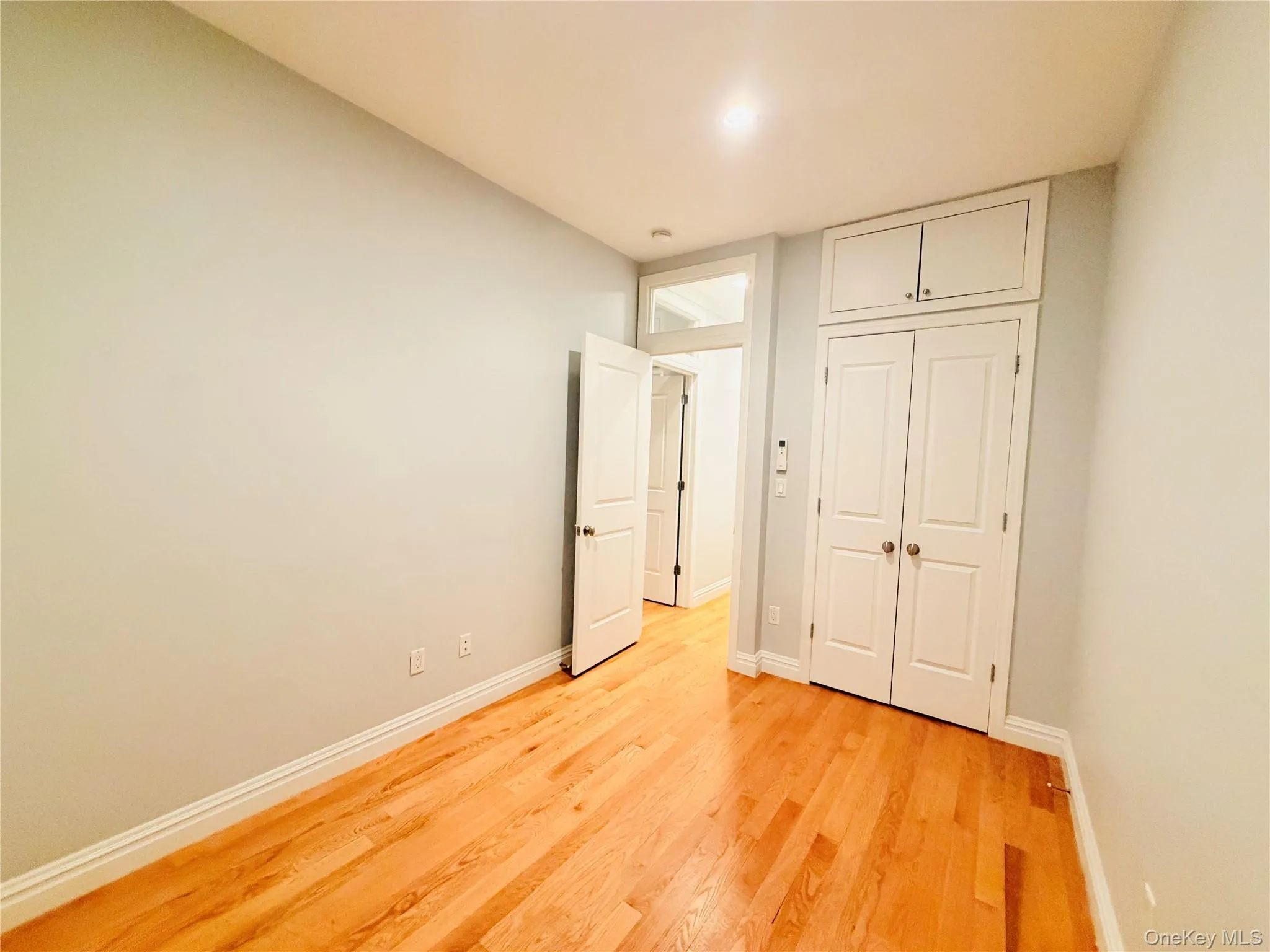 Unfurnished bedroom featuring light wood-style floors and a closet Unfurnished bedroom featuring light wood-style floors and a closet