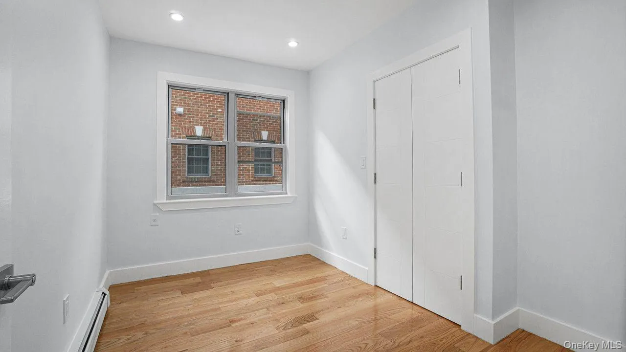 Unfurnished bedroom featuring light wood-type flooring, a baseboard heating unit, and recessed lighting Unfurnished bedroom featuring light wood-type flooring, a baseboard heating unit, and recessed lighting
