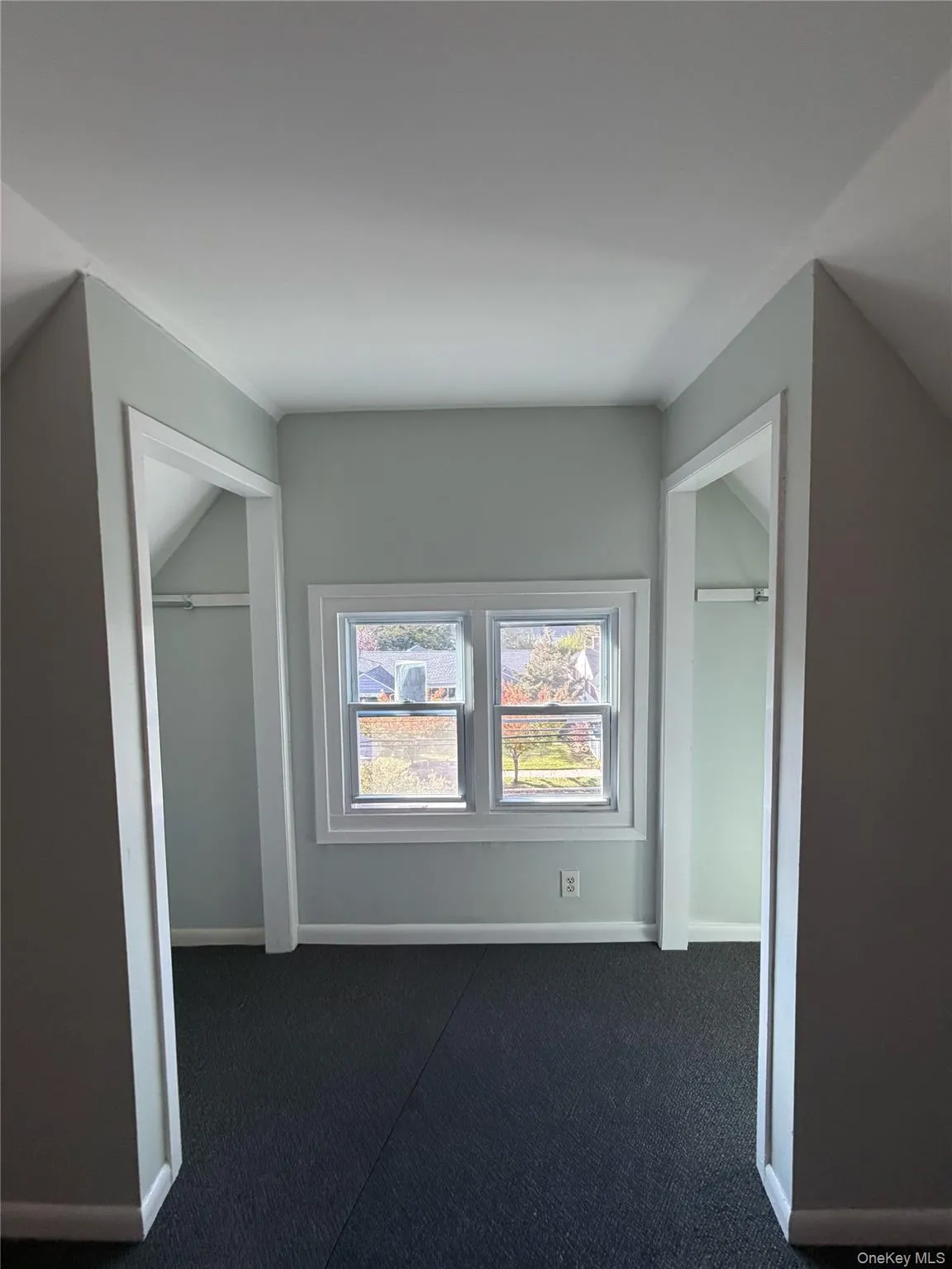 Additional living space with vaulted ceiling and carpet floors Additional living space with vaulted ceiling and carpet floors