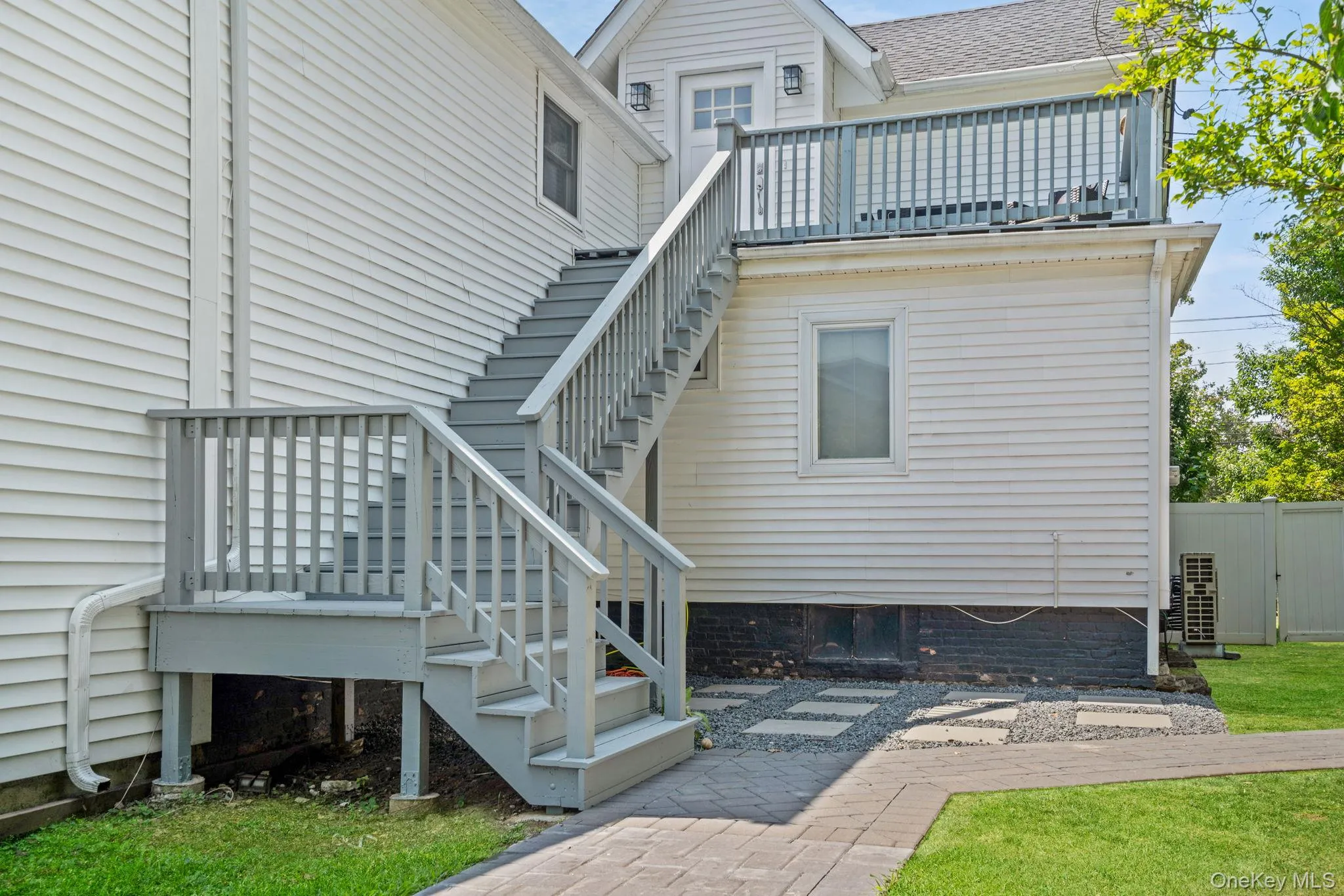 Back of house with stairway Back of house with stairway