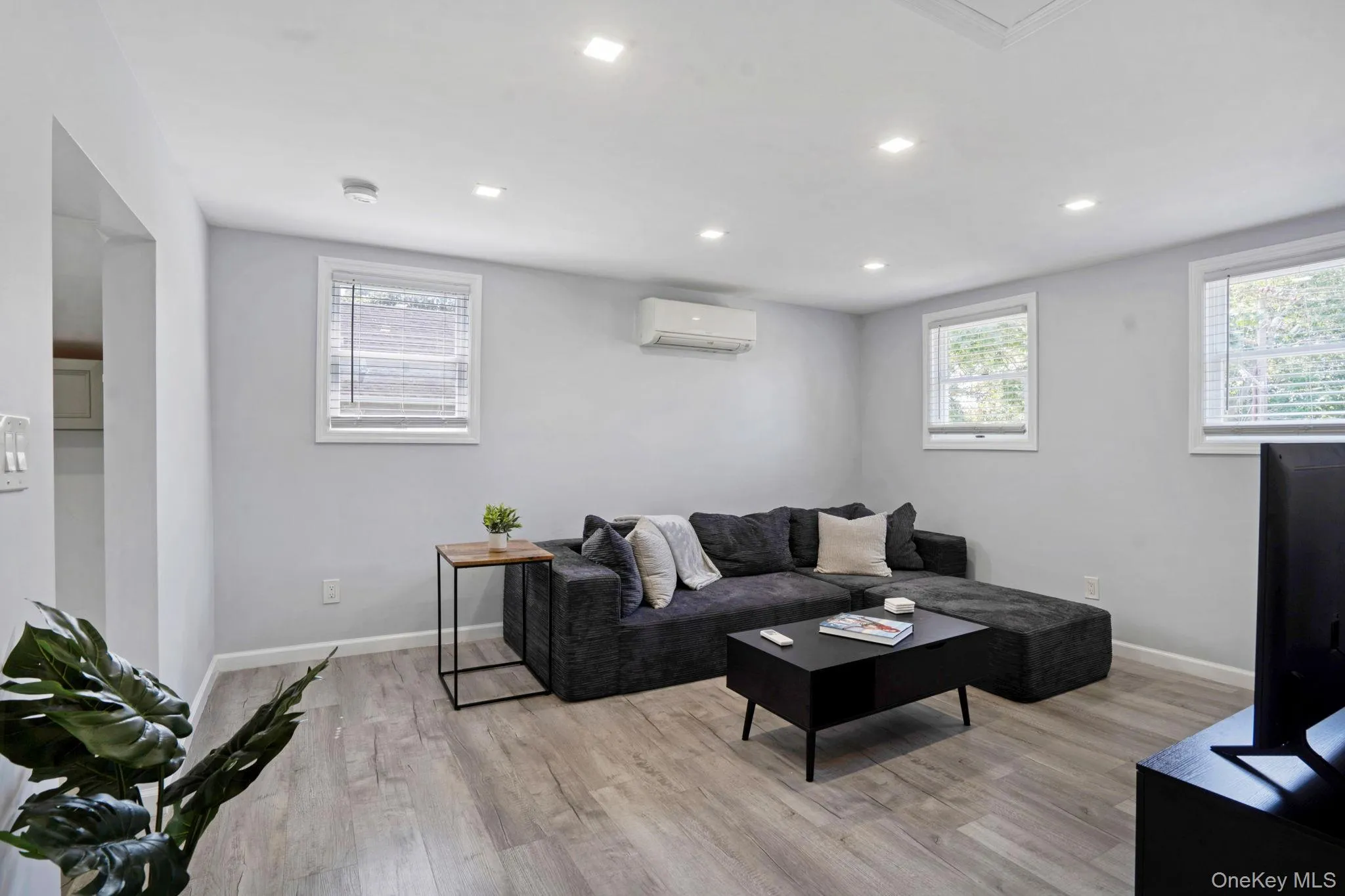 Living room with light wood finished floors, recessed lighting, and healthy amount of natural light Living room with light wood finished floors, recessed lighting, and healthy amount of natural light