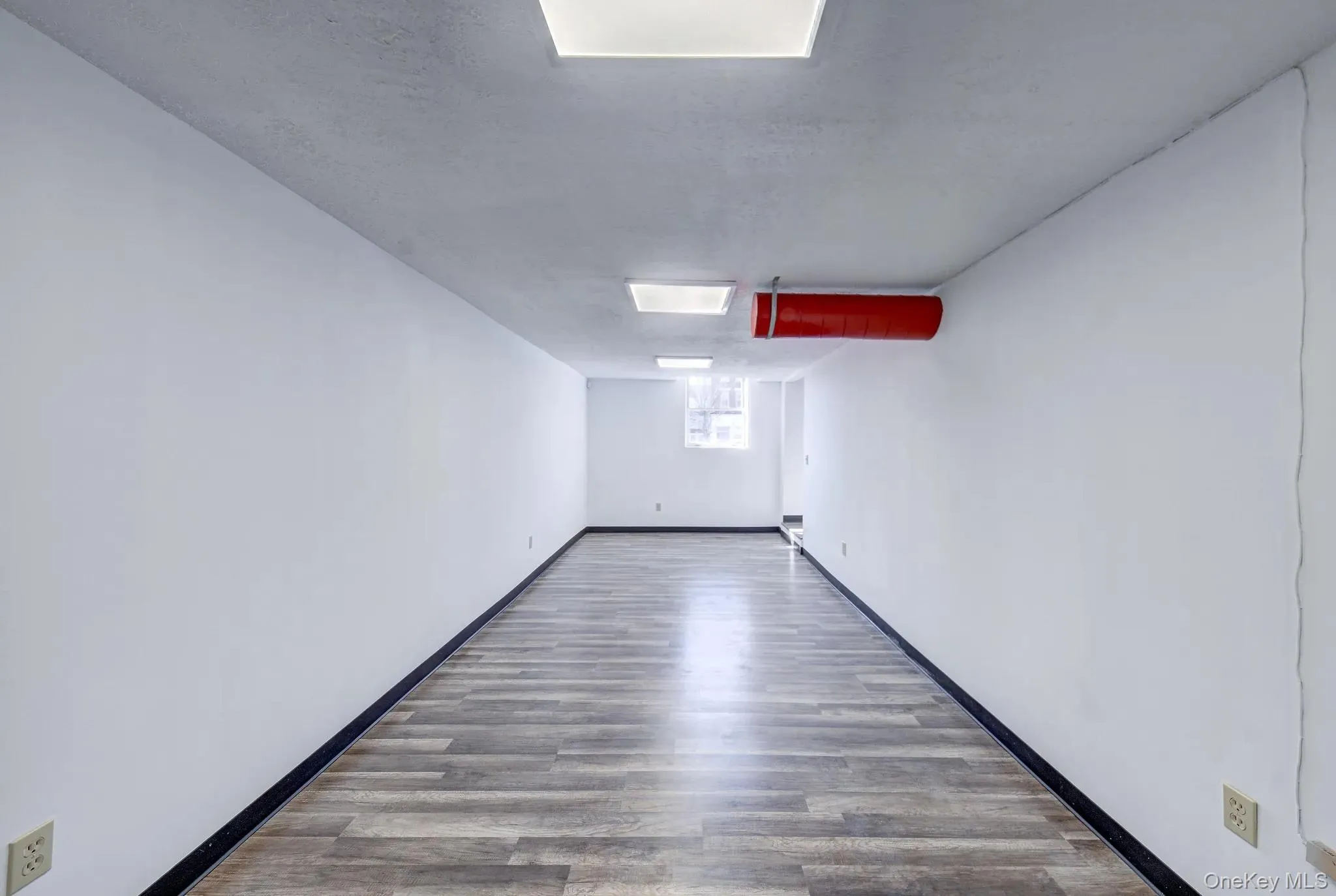 Unfurnished room featuring wood finished floors Unfurnished room featuring wood finished floors