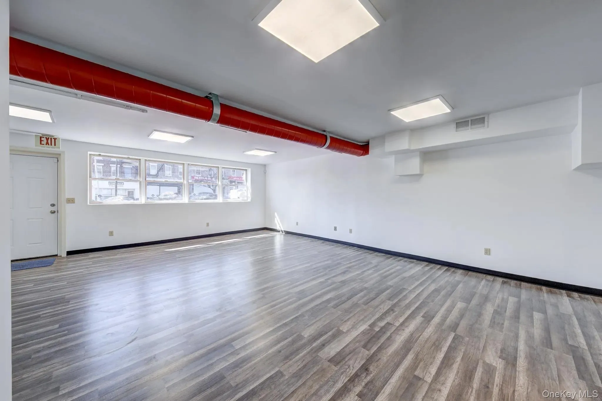 Empty room with wood finished floors and baseboards Empty room with wood finished floors and baseboards