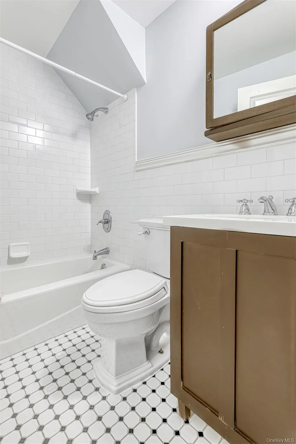 Bathroom with washtub / shower combination, tile walls, and vanity Bathroom with washtub / shower combination, tile walls, and vanity