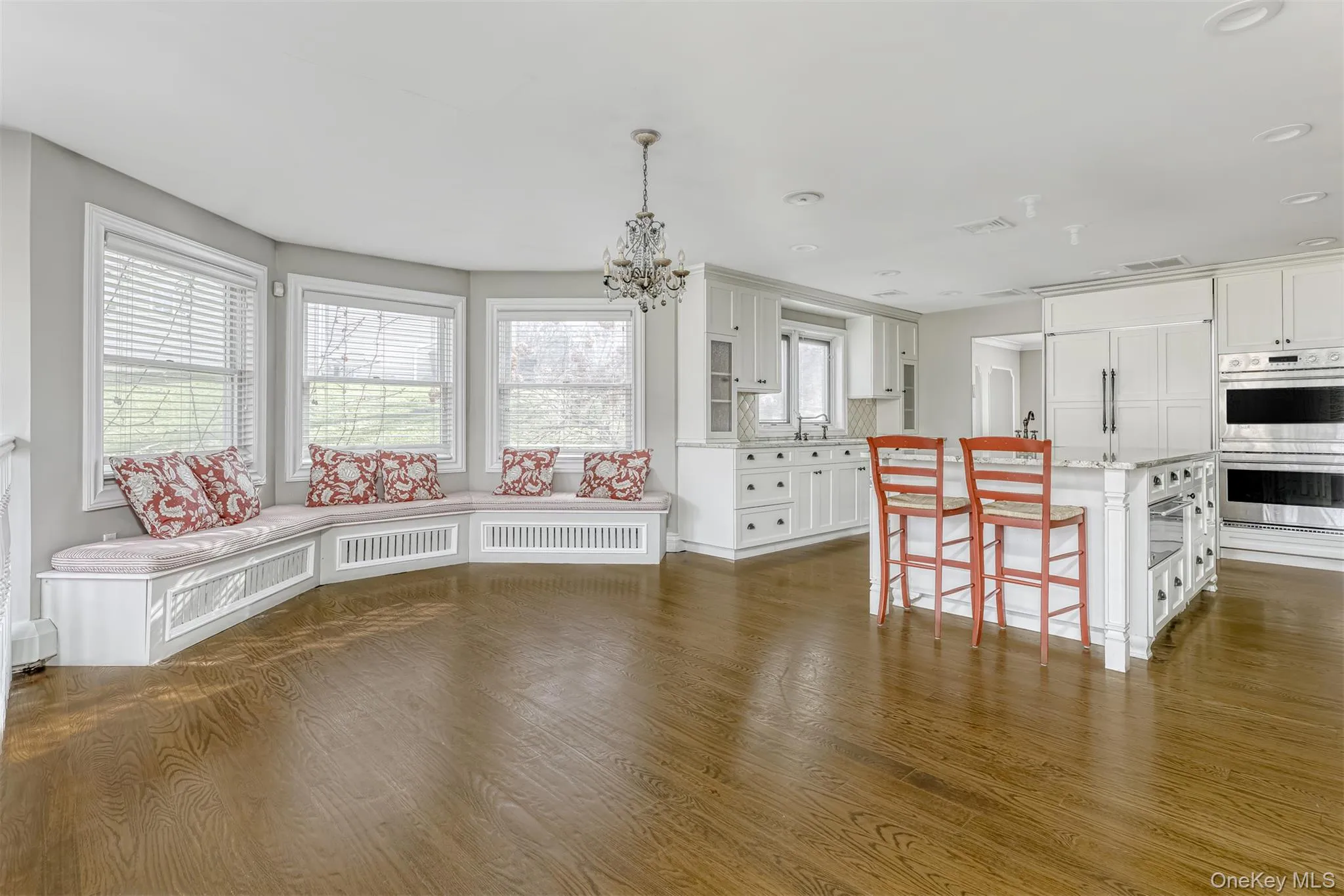 Dining room featuring dark wood-style flooring, a chandelier, and recessed lighting Dining room featuring dark wood-style flooring, a chandelier, and recessed lighting