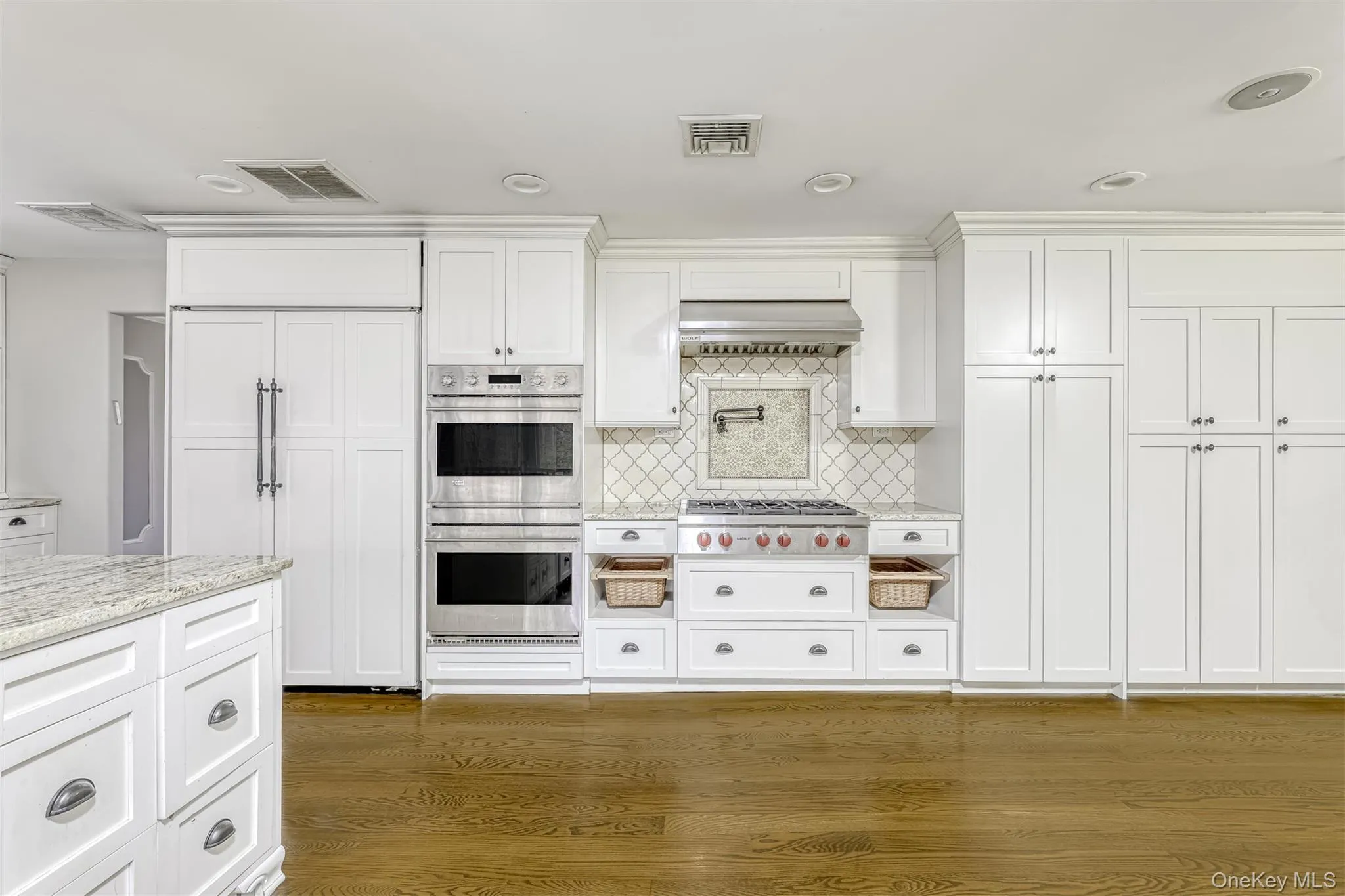 Kitchen featuring stainless steel appliances, tasteful backsplash, white cabinets, light stone counters, and recessed lighting Kitchen featuring stainless steel appliances, tasteful backsplash, white cabinets, light stone counters, and recessed lighting