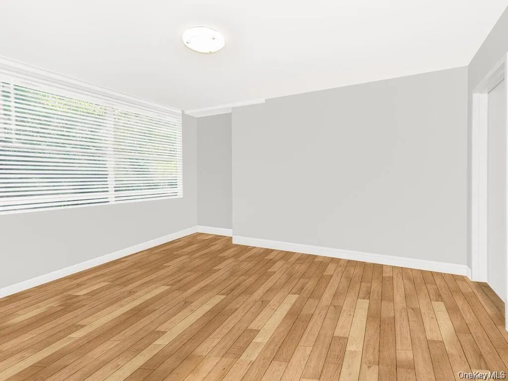 Empty room featuring light wood-type flooring and baseboards Empty room featuring light wood-type flooring and baseboards