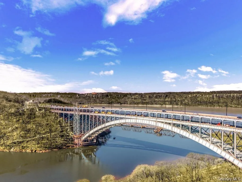 Drone / aerial view of a notable bridge and a nearby body of water Drone / aerial view of a notable bridge and a nearby body of water