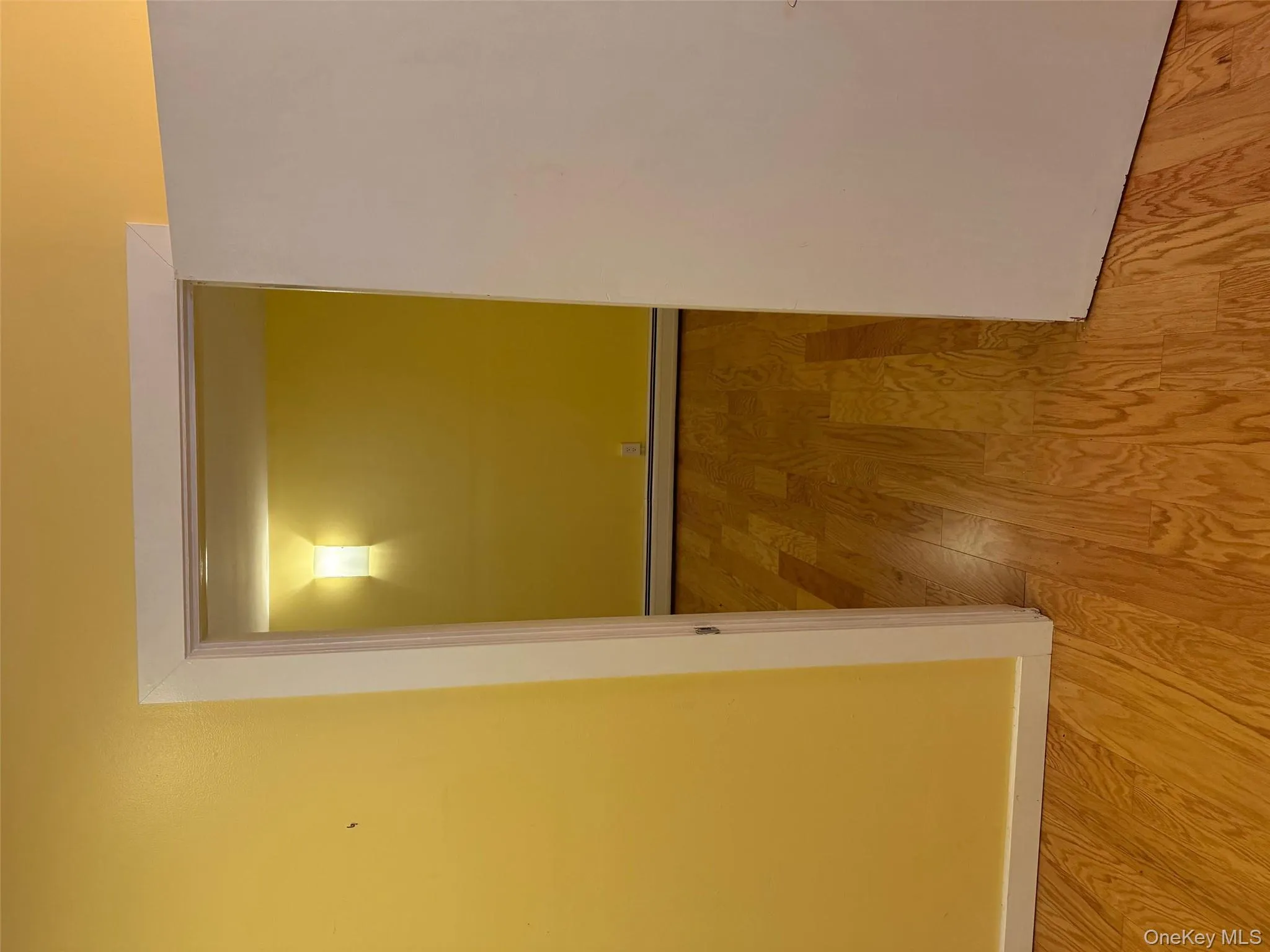 Hall featuring light wood-style flooring and baseboard heating Hall featuring light wood-style flooring and baseboard heating