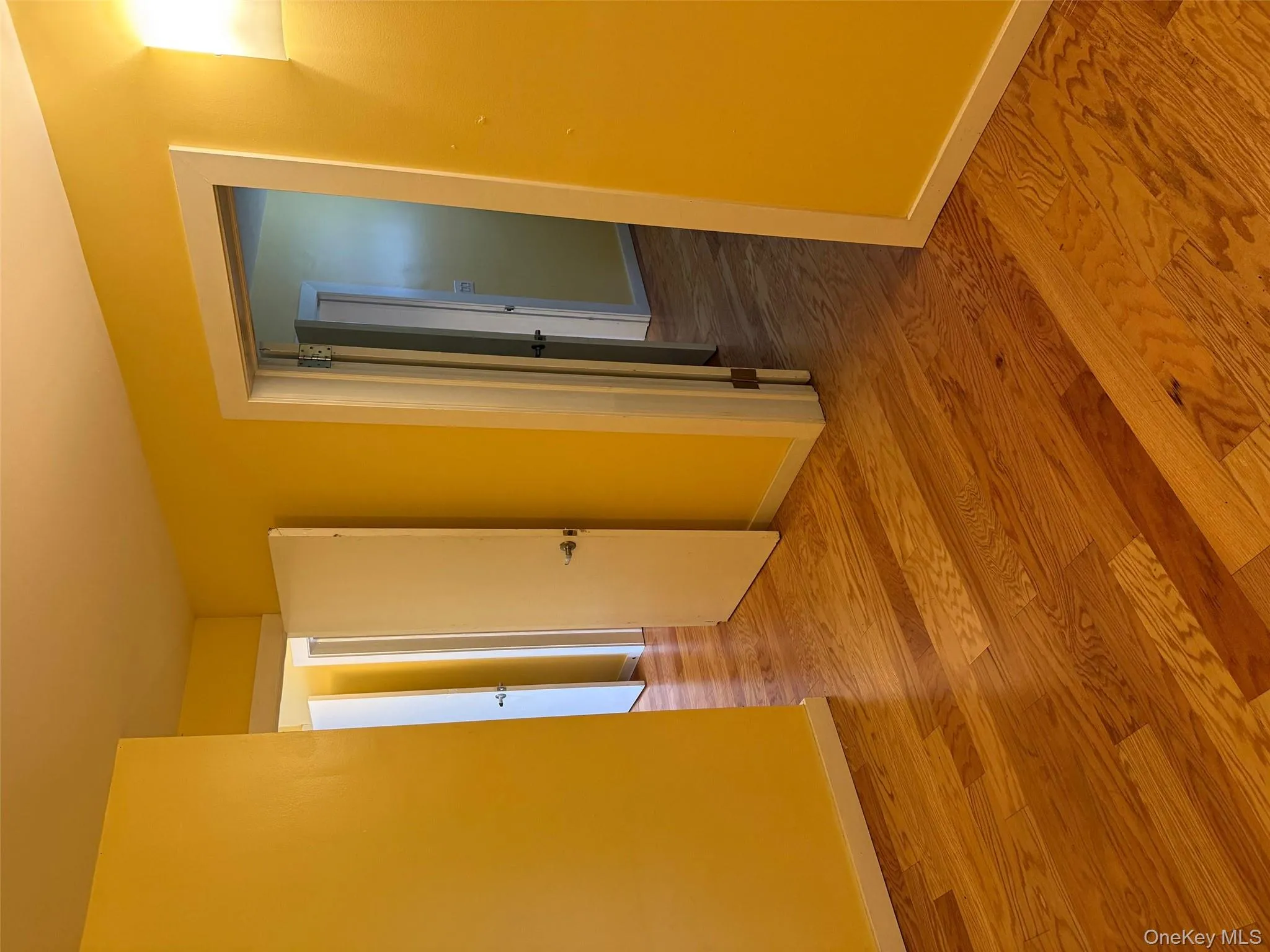 Hallway with light wood-style flooring and baseboards Hallway with light wood-style flooring and baseboards