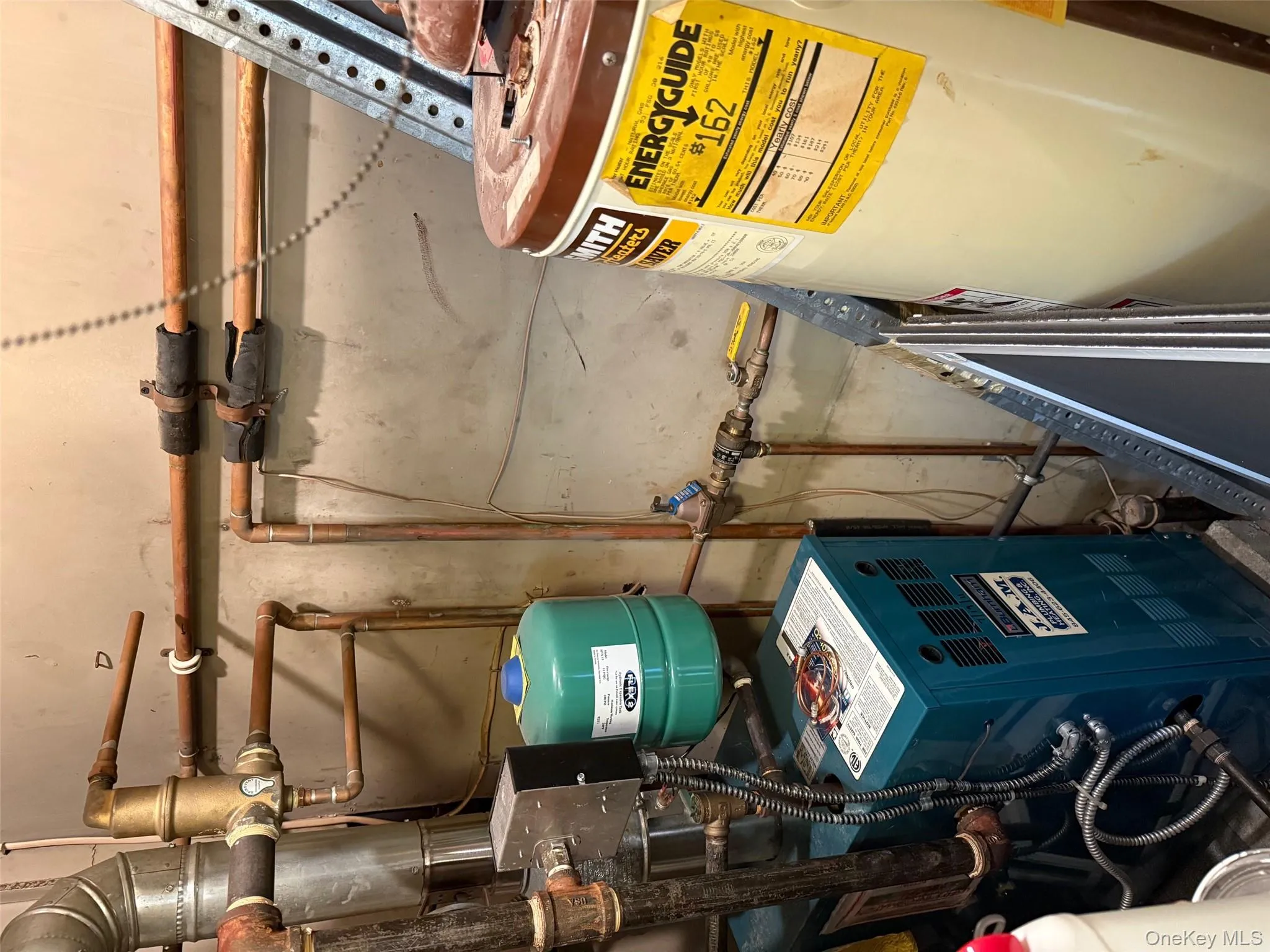 Utility room featuring water heater and a heating unit Utility room featuring water heater and a heating unit